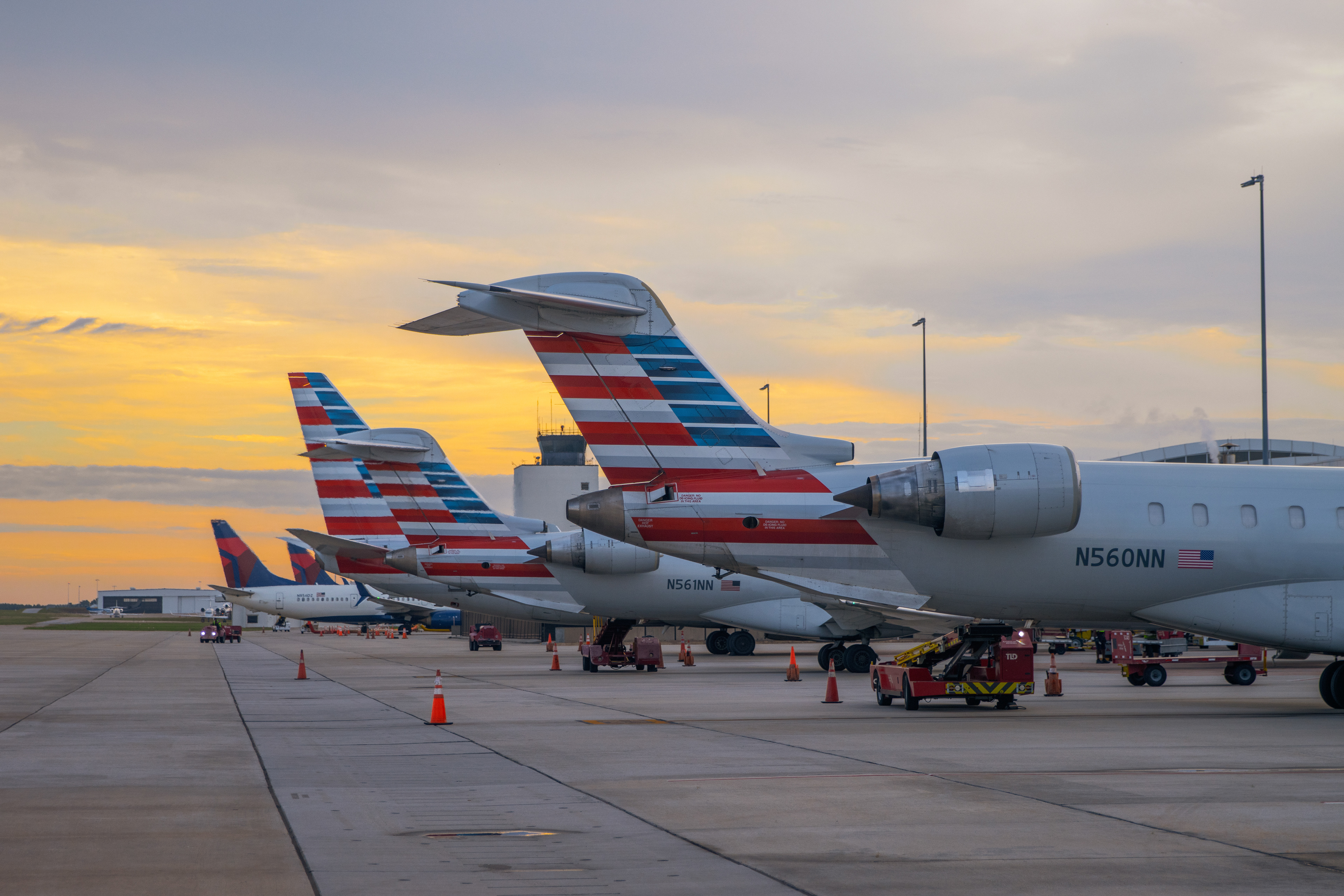 Plane tails at sunrise with the ATC Tower in the background.