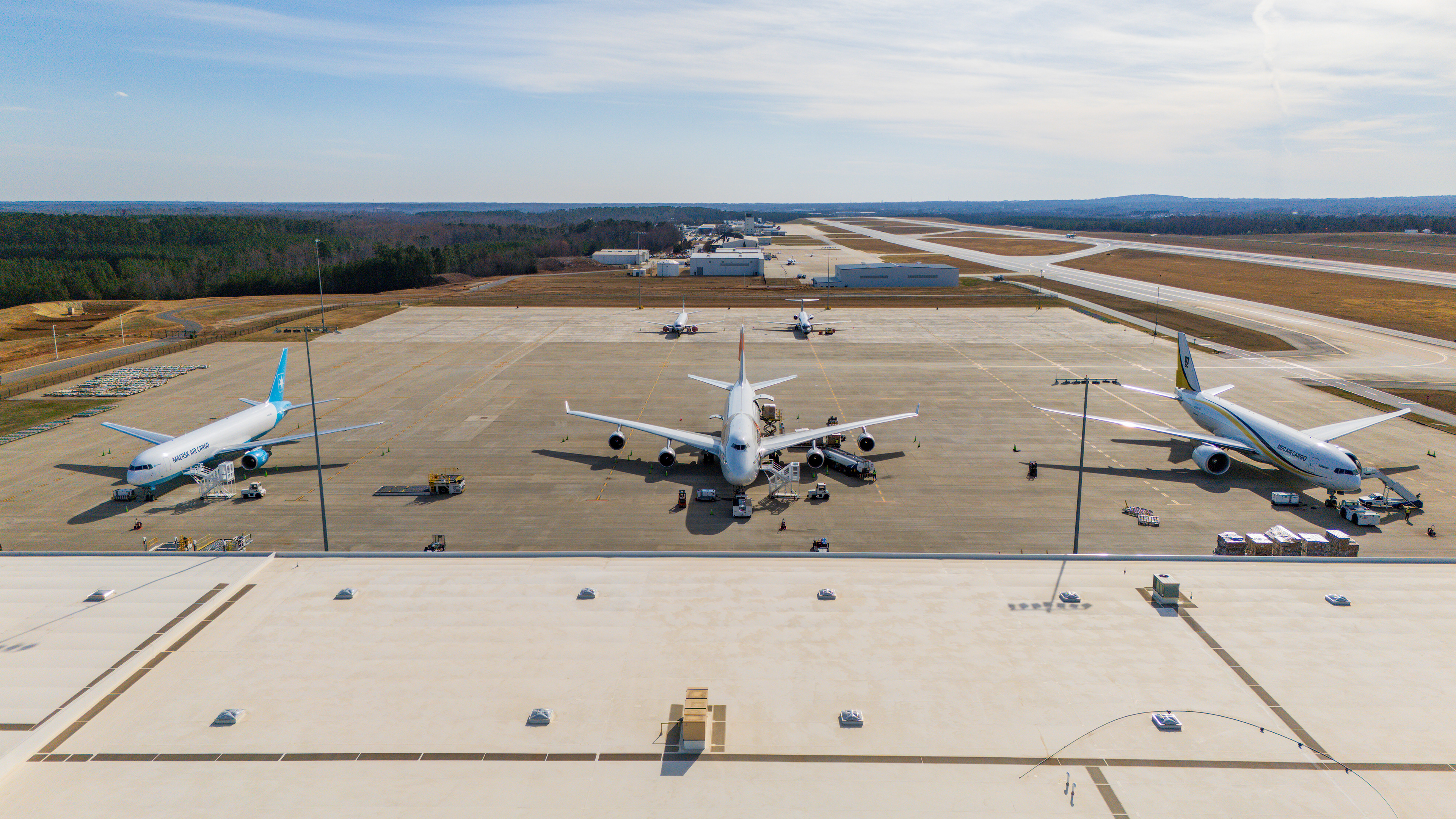 Drone shot of three wide body aircraft at the cargo facility.