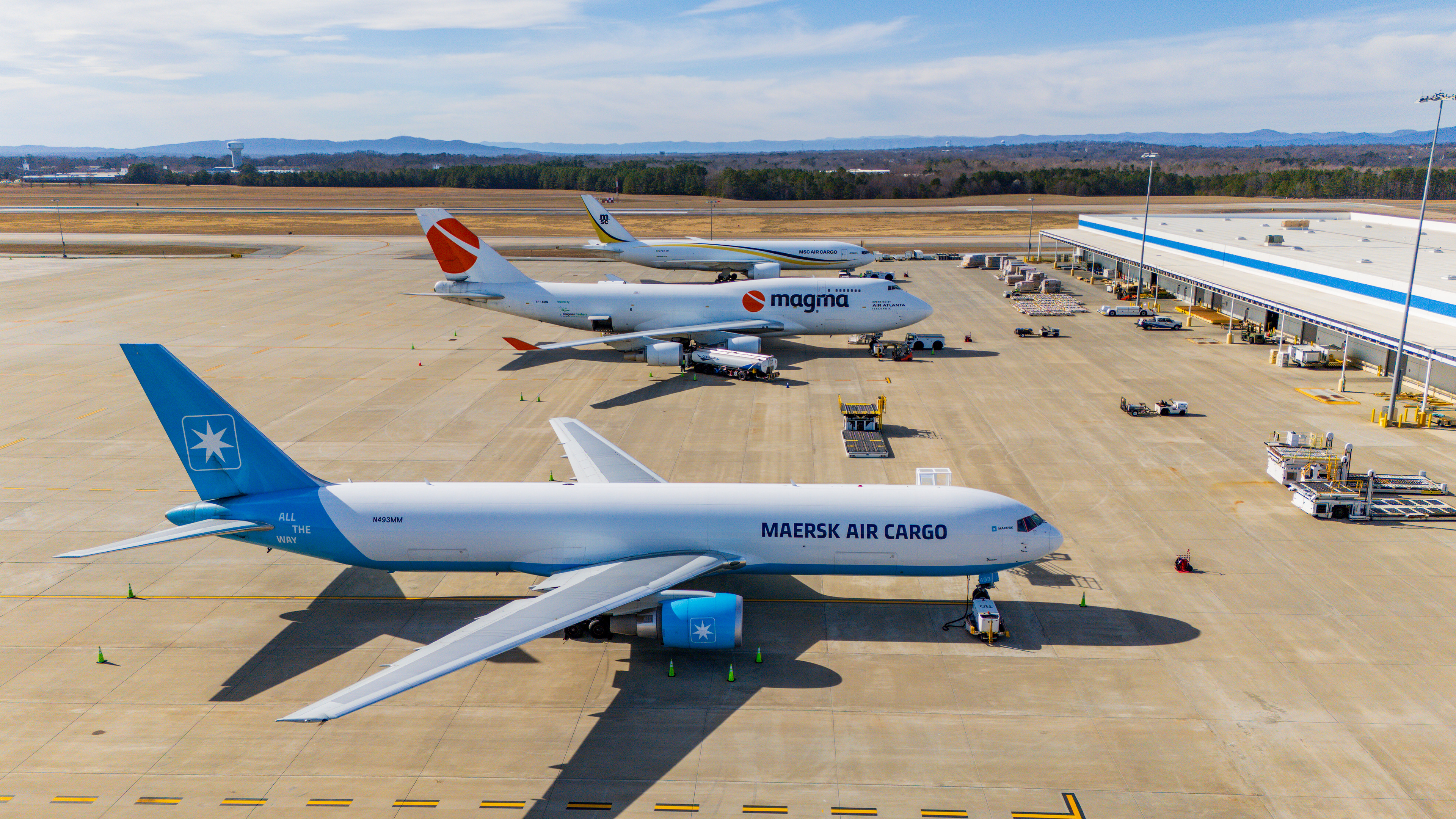 Drone shot of three wide body aircraft at the cargo facility.
