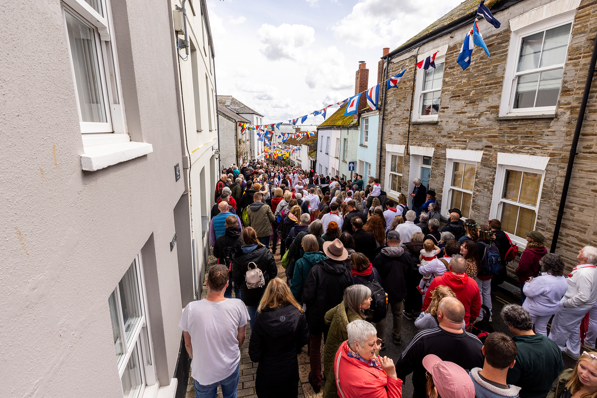 Crowds gather in the streets of Padstow for the annual May Day ‘Obby Oss’ celebrations. The tradition is seen to welcome the coming of summer and its origins are unknown, however the earliest mentions of its celebrations date back to 1803. © Luke Williams, 2024. All rights reserved.
