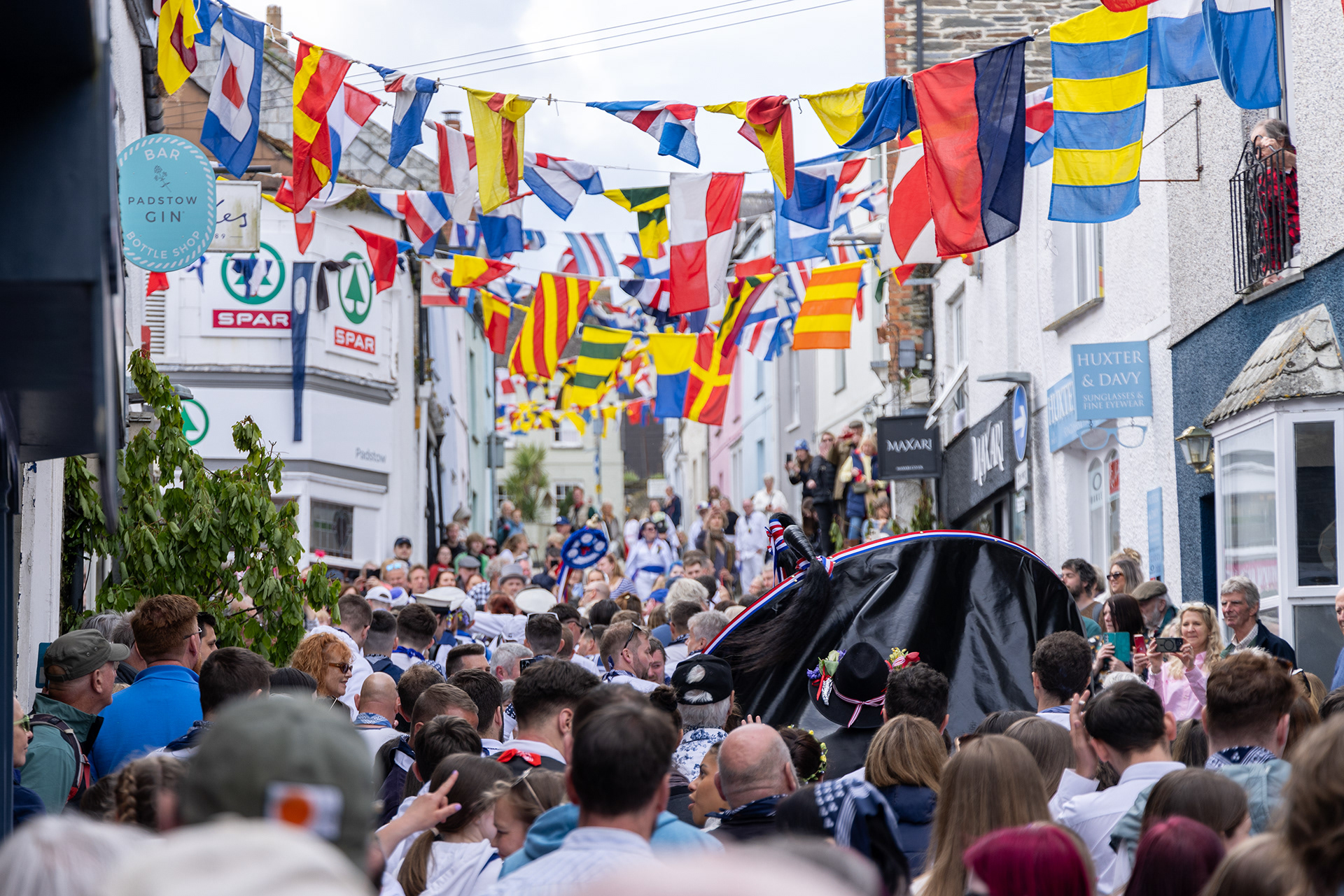 Crowds gather in the streets of Padstow for the annual May Day ‘Obby Oss’ celebrations. The tradition is seen to welcome the coming of summer and its origins are unknown, however the earliest mentions of its celebrations date back to 1803. © Luke Williams, 2024. All rights reserved.