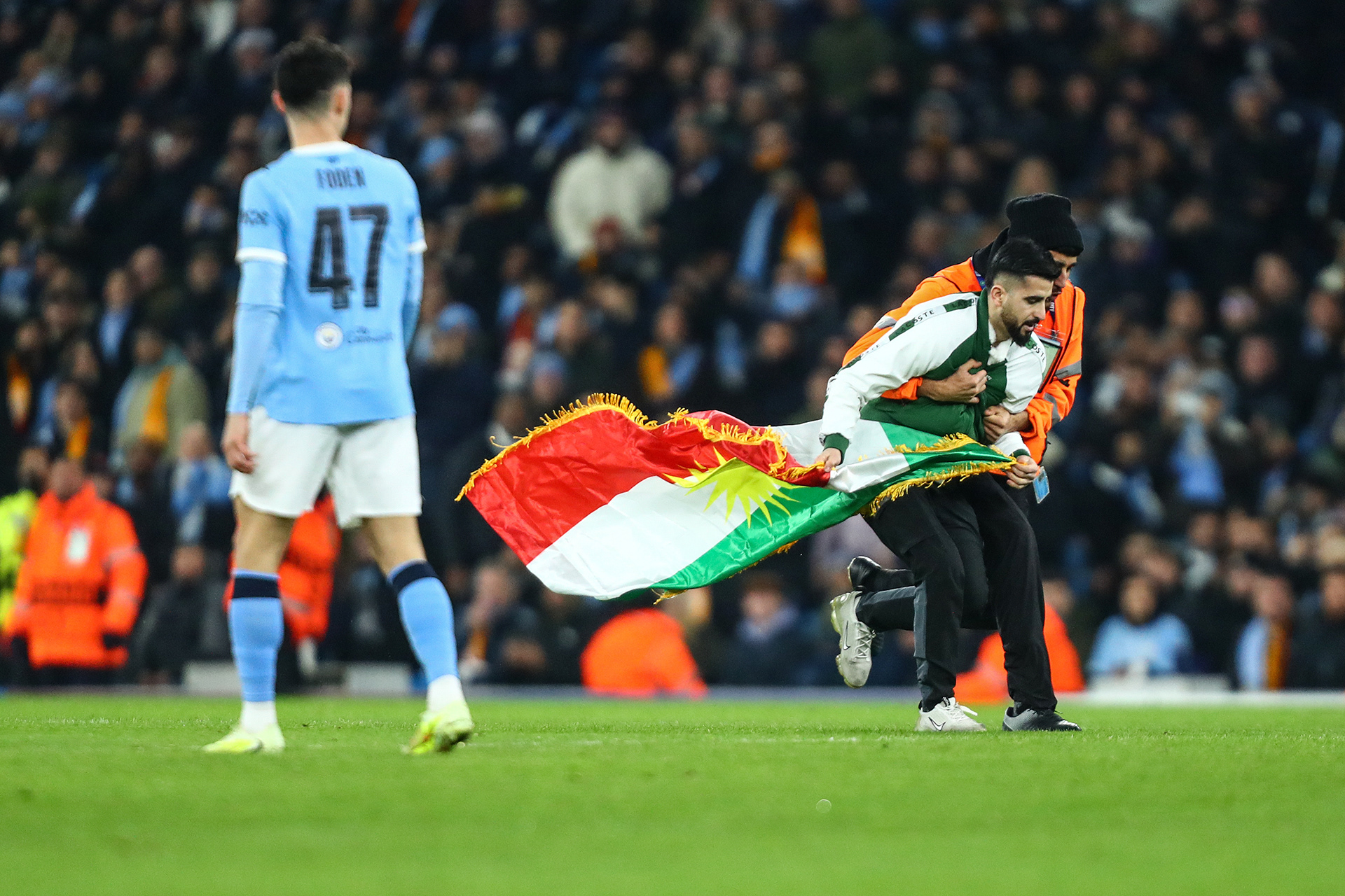 Pitch invaders are tackled by stewards during the Manchester City v Galatasaray S.K. UEFA Champions League MD8 match at the Etihad Stadium, Manchester, England on 28 January 2026 @everysecondmedia
