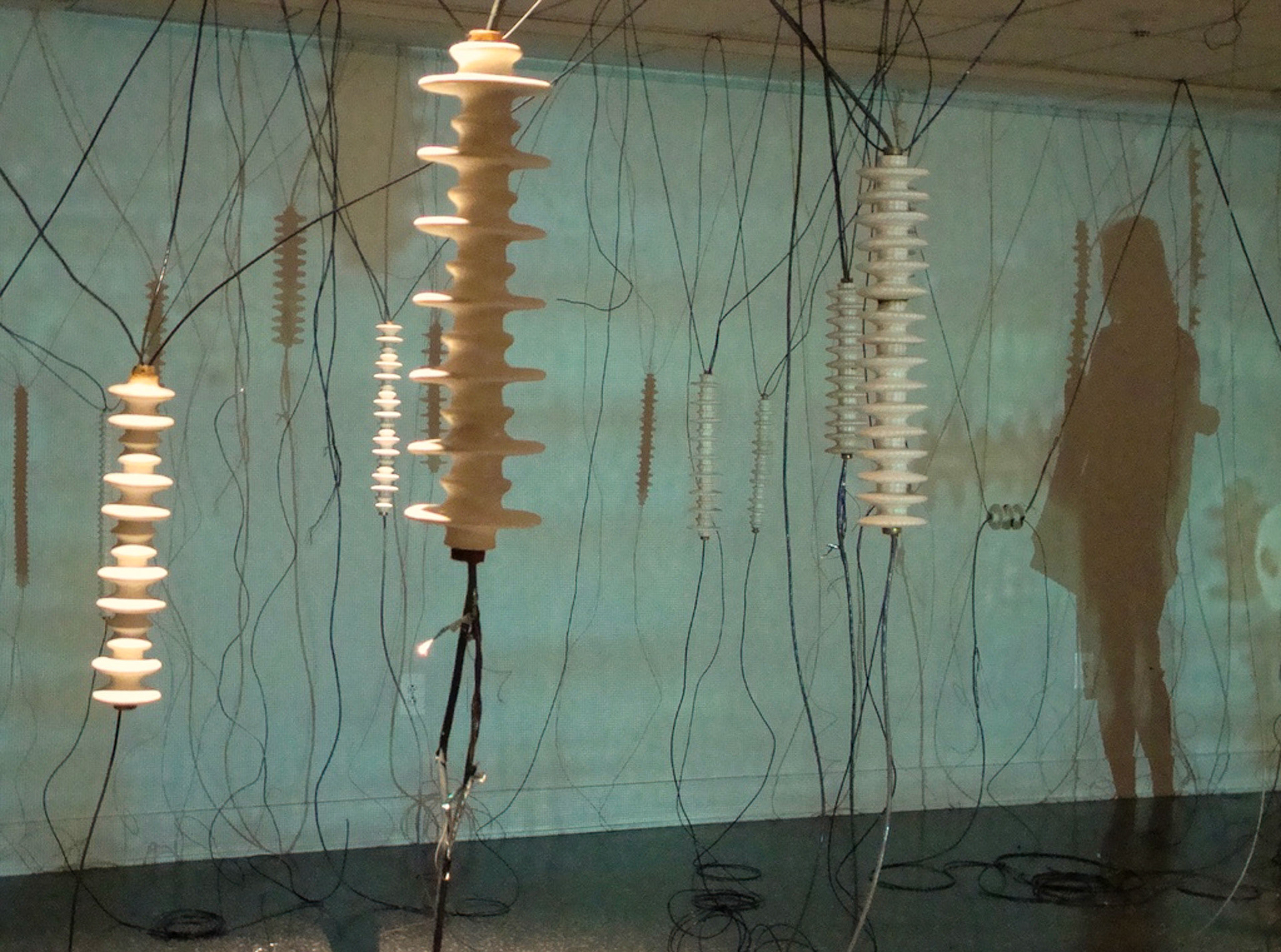 White Noise Porcelain, gold luster, wire, electronic parts, video projection., 2010