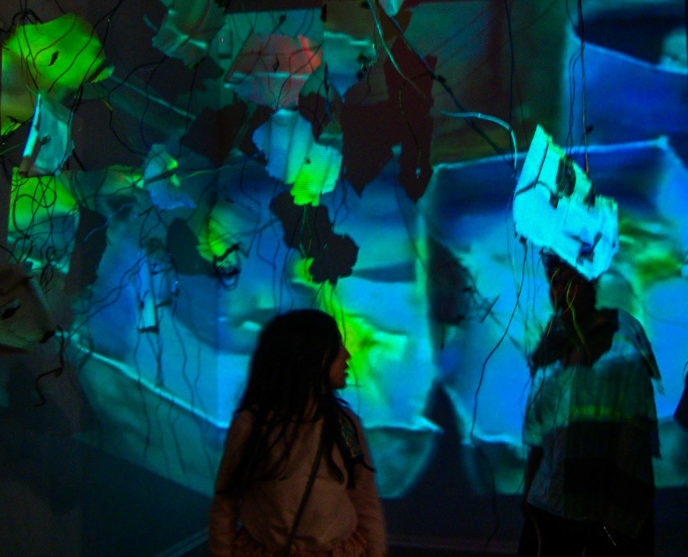 Diffusion  Porcelain, gold luster, gold leaf, found computer components, wire, video projection. 2011