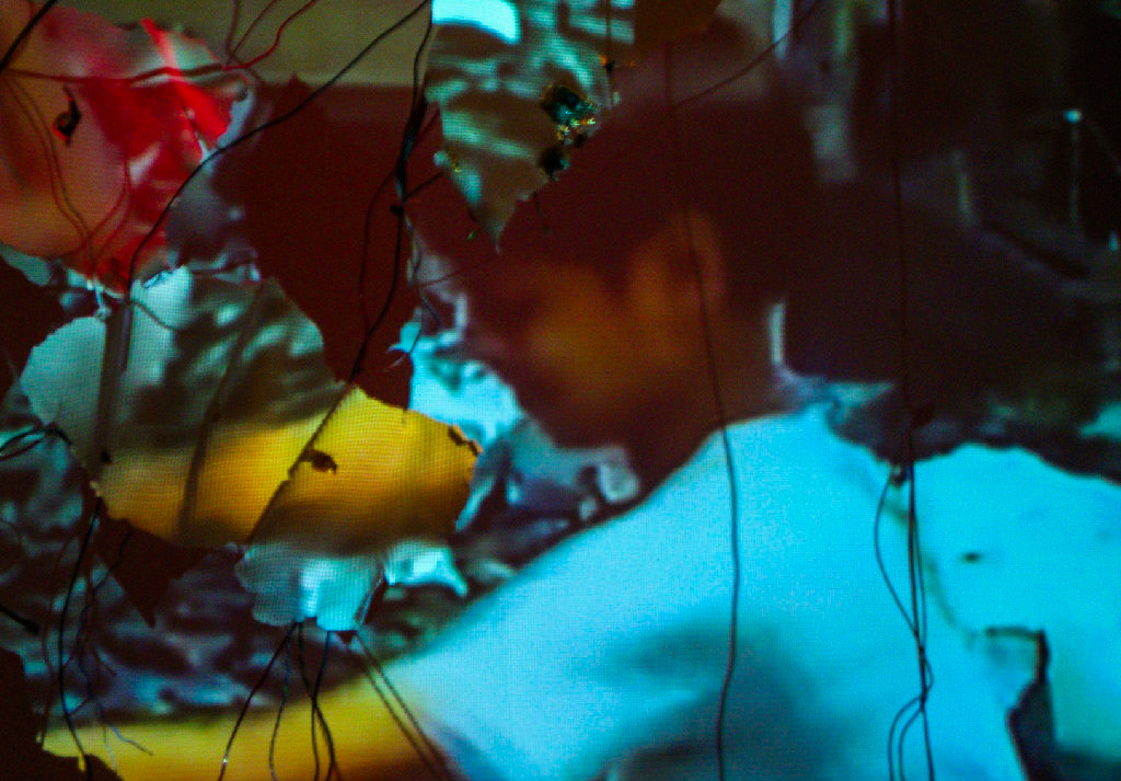 Diffusion  Porcelain, gold luster, gold leaf, found computer components, wire, video projection., 2011