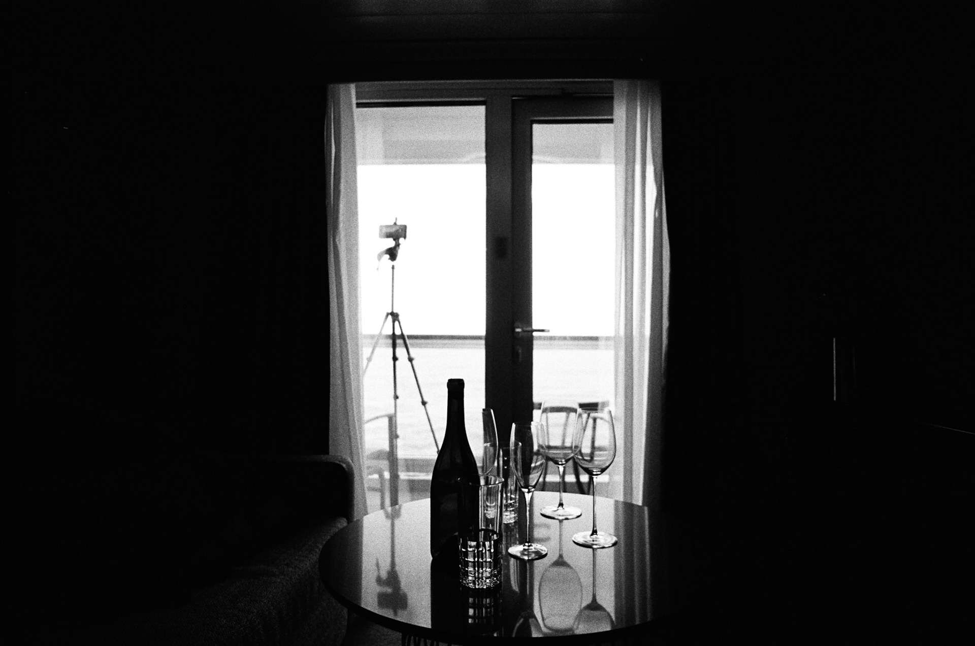 Love this little shot from the room, my phone in the background recording a time lapse of us arrive in to port, some left overs from the night before on the table!  Nikon FE, 50mm, Ilford HP5