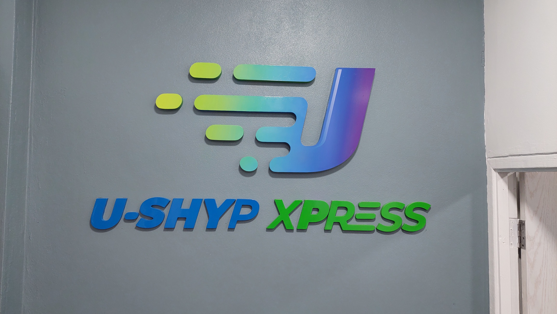 U-Shyp Xpress logo mounted on their office wall