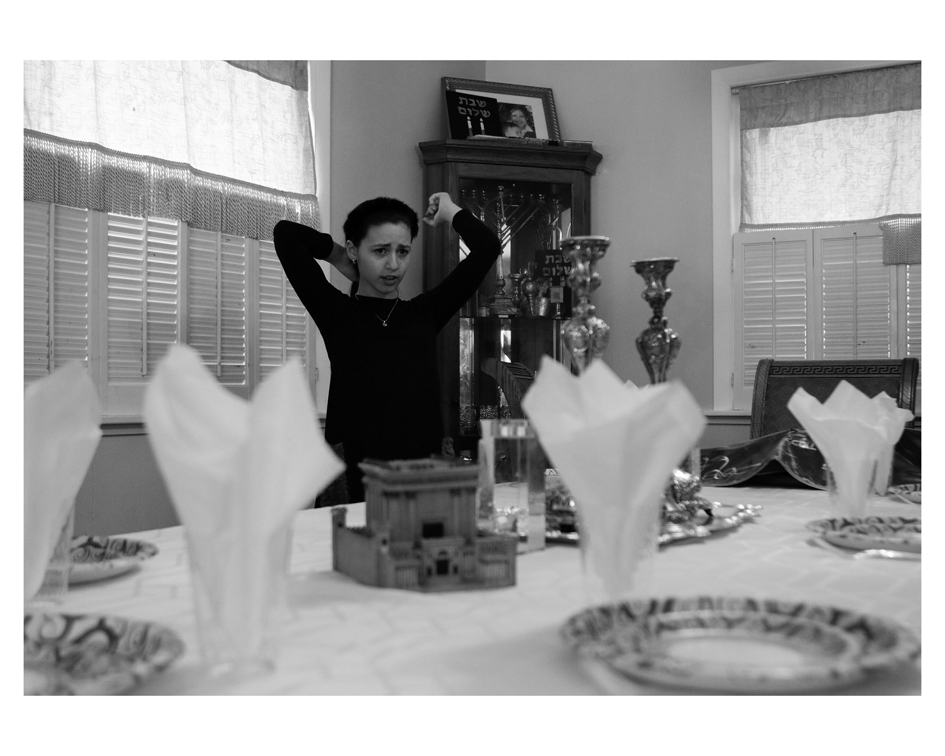 Chani looks around frantically as she rushes to set the table before Shabbos.