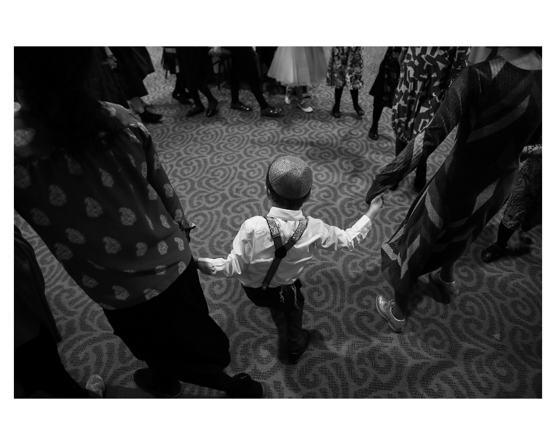 Levi dances with friends and family. Chani's brothers and father were the only men accepted to attend her bat mitzvah, per tradition. 