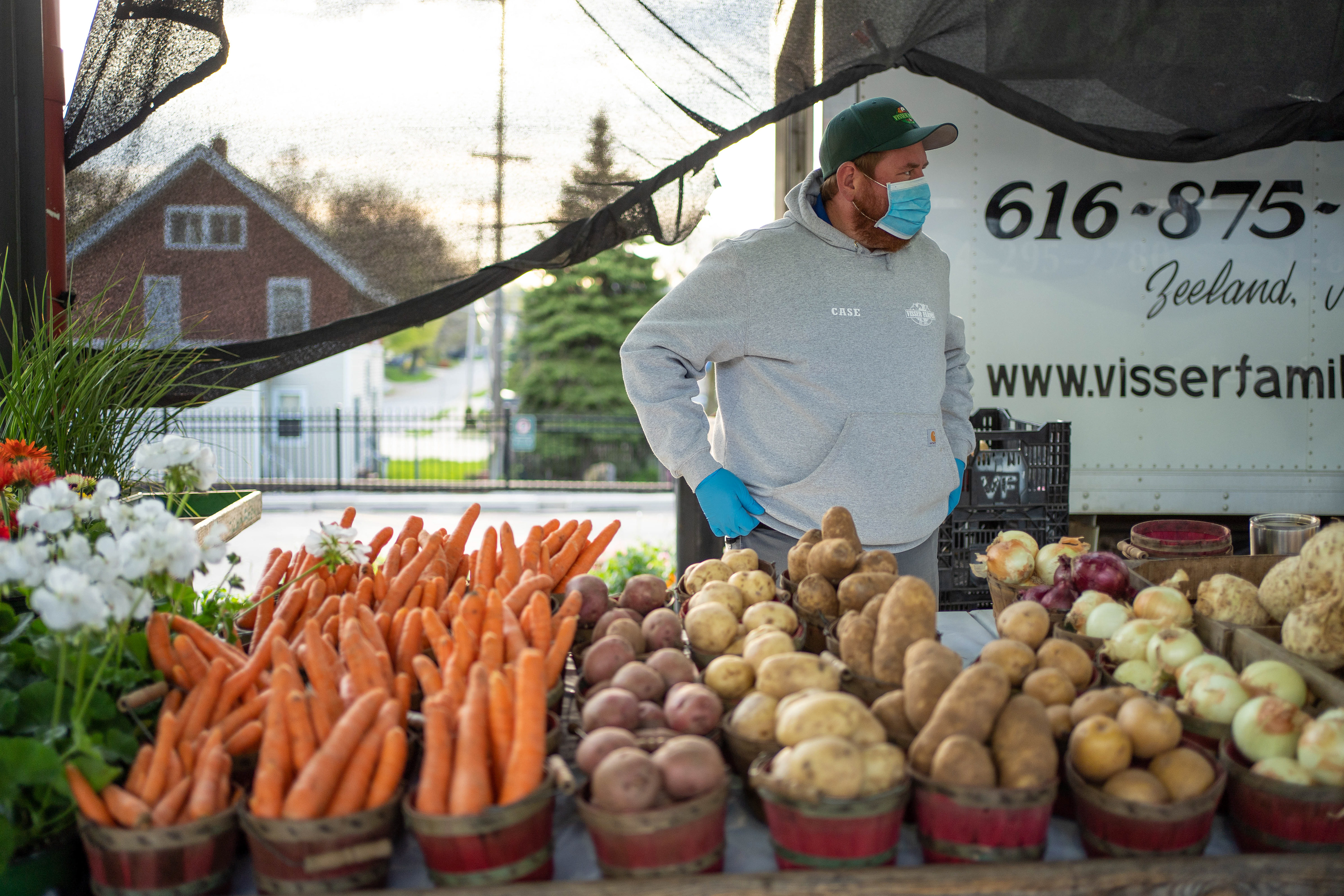 Case Visser of Visser Farms waits for a customer at Fulton Street Farmers Market on Saturday, May 2, 2020 in Grand Rapids. Producers and vendors are all wearing masks to prevent the spread of COVID-19. 