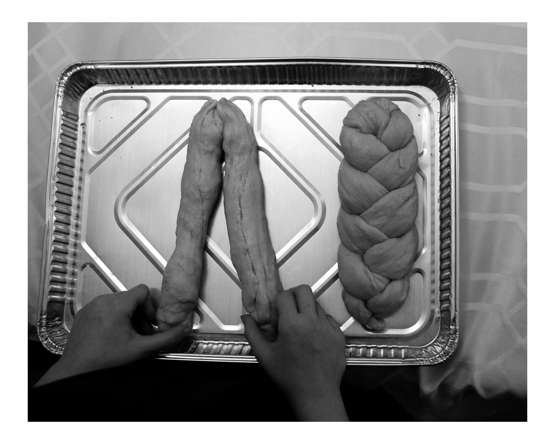 Chani Weingarten, 11, braids fresh challah dough before Shabbos. 