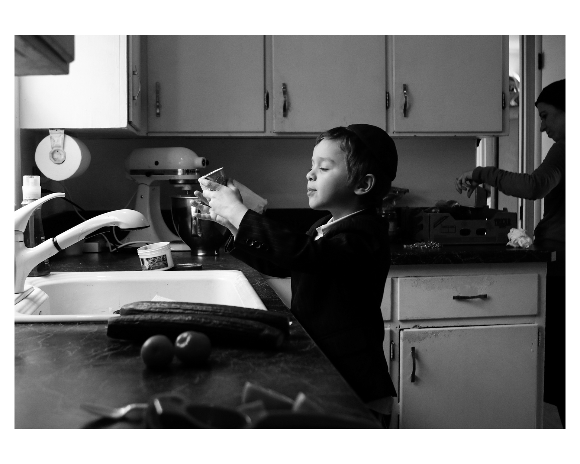 Levi washes his older brother's prayer cup before Shabbos. Avremel, 14, lives with his cousins in Arkansas where he attends Hebrew school.