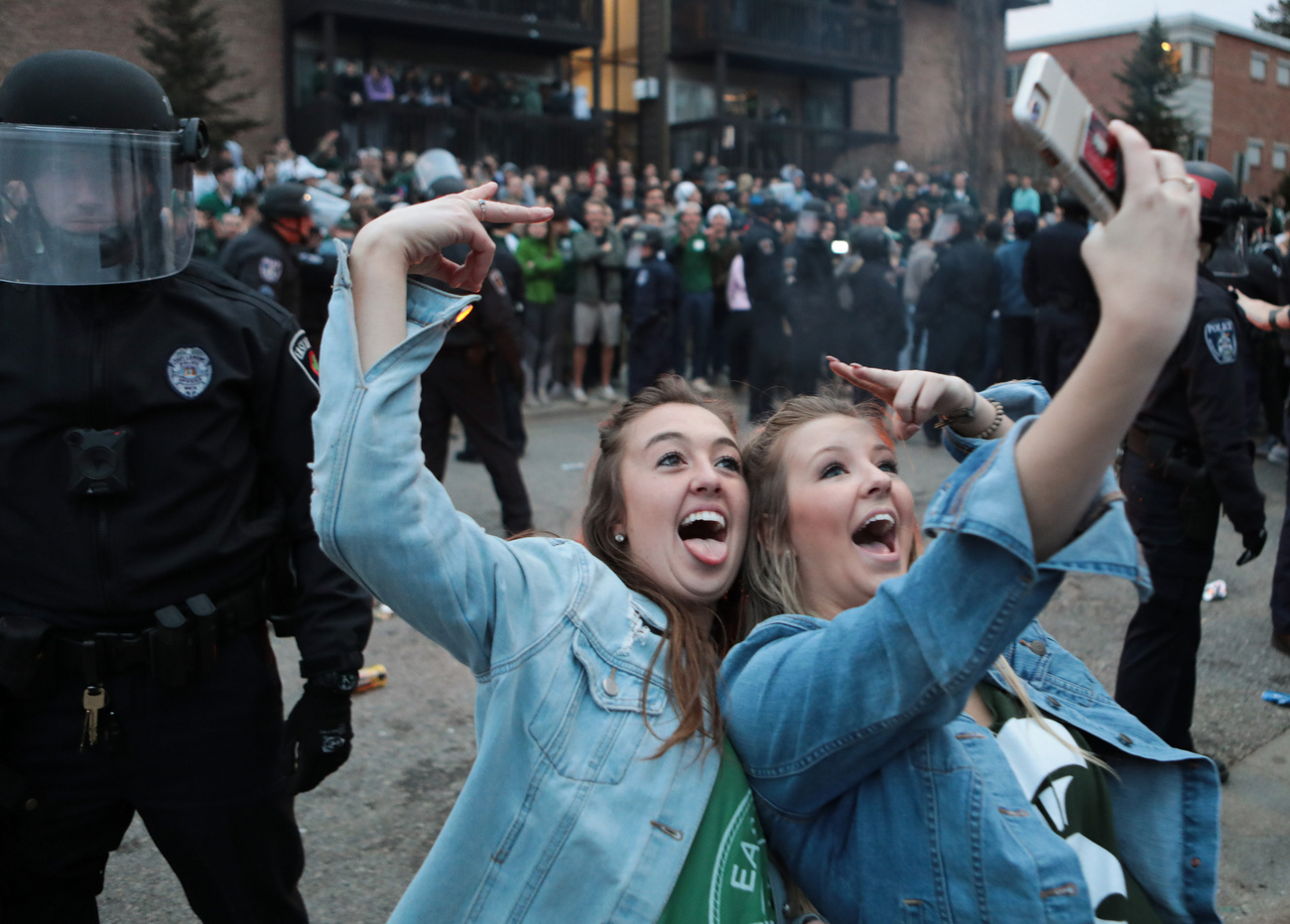 Spartan fans celebrate at Cedar Village Apartments in East Lansing, Michigan, following Michigan State's win against Duke to advance to the Final Four March 31, 2019.