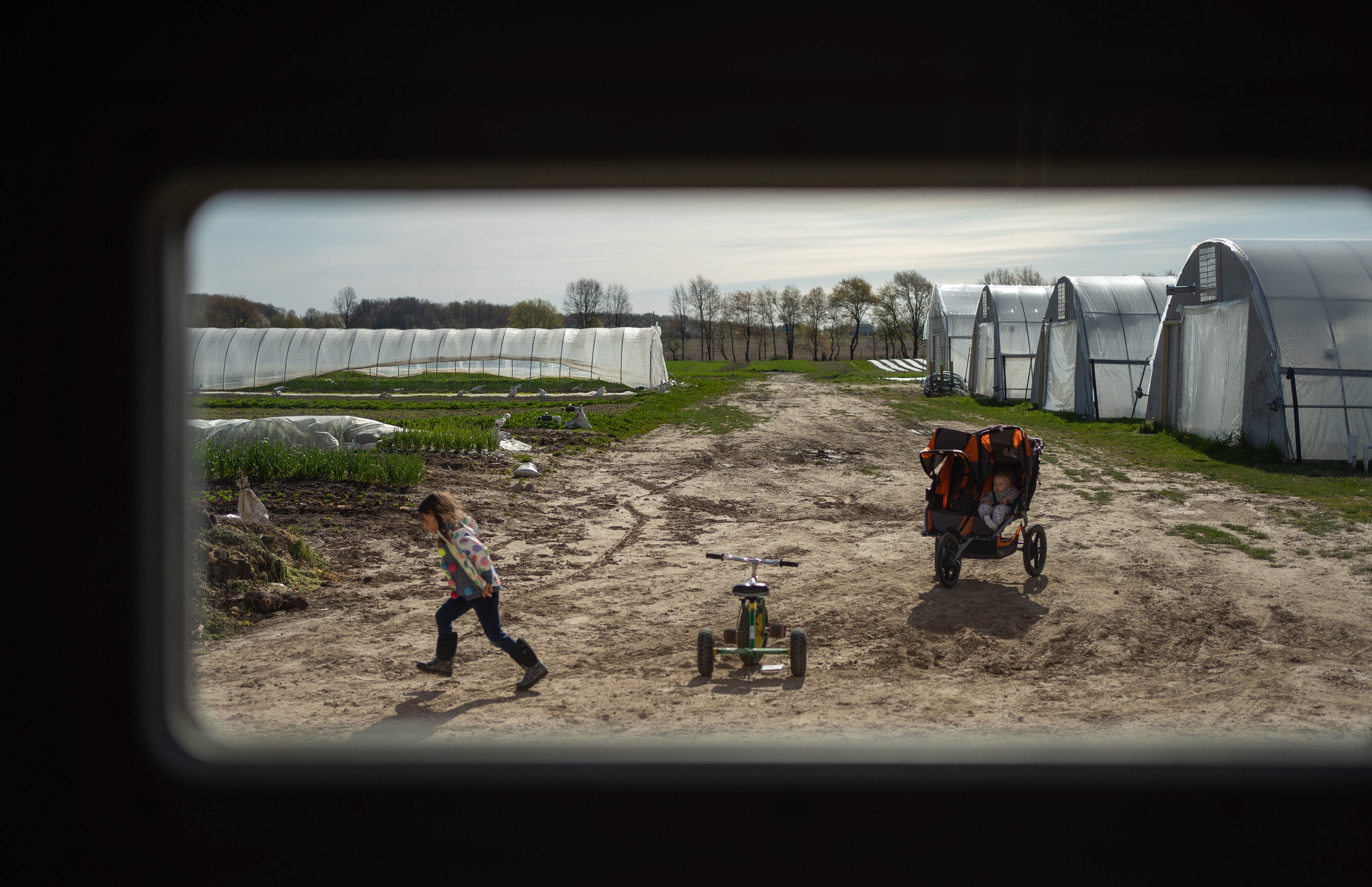 Olive Anderson, 5, runs after her brother on their farm in Ada on Wednesday, May 7, 2020.