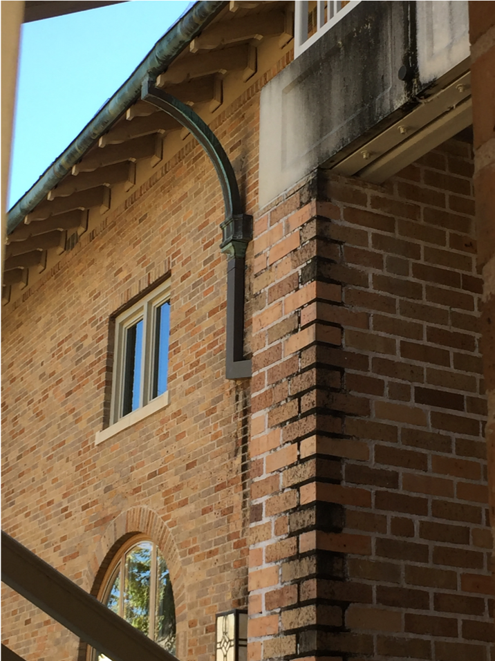 soiling on brick masonry and concrete blocks. light green patina on gutters.