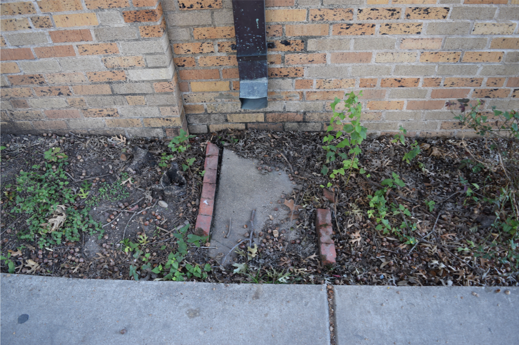insufficient drainage due to sunken concrete splash block