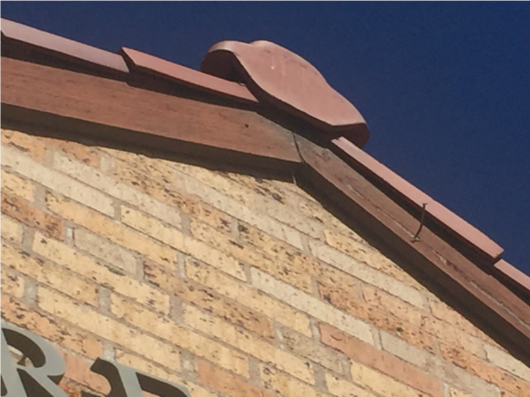 warped wood trim, faded paint, and loose nail