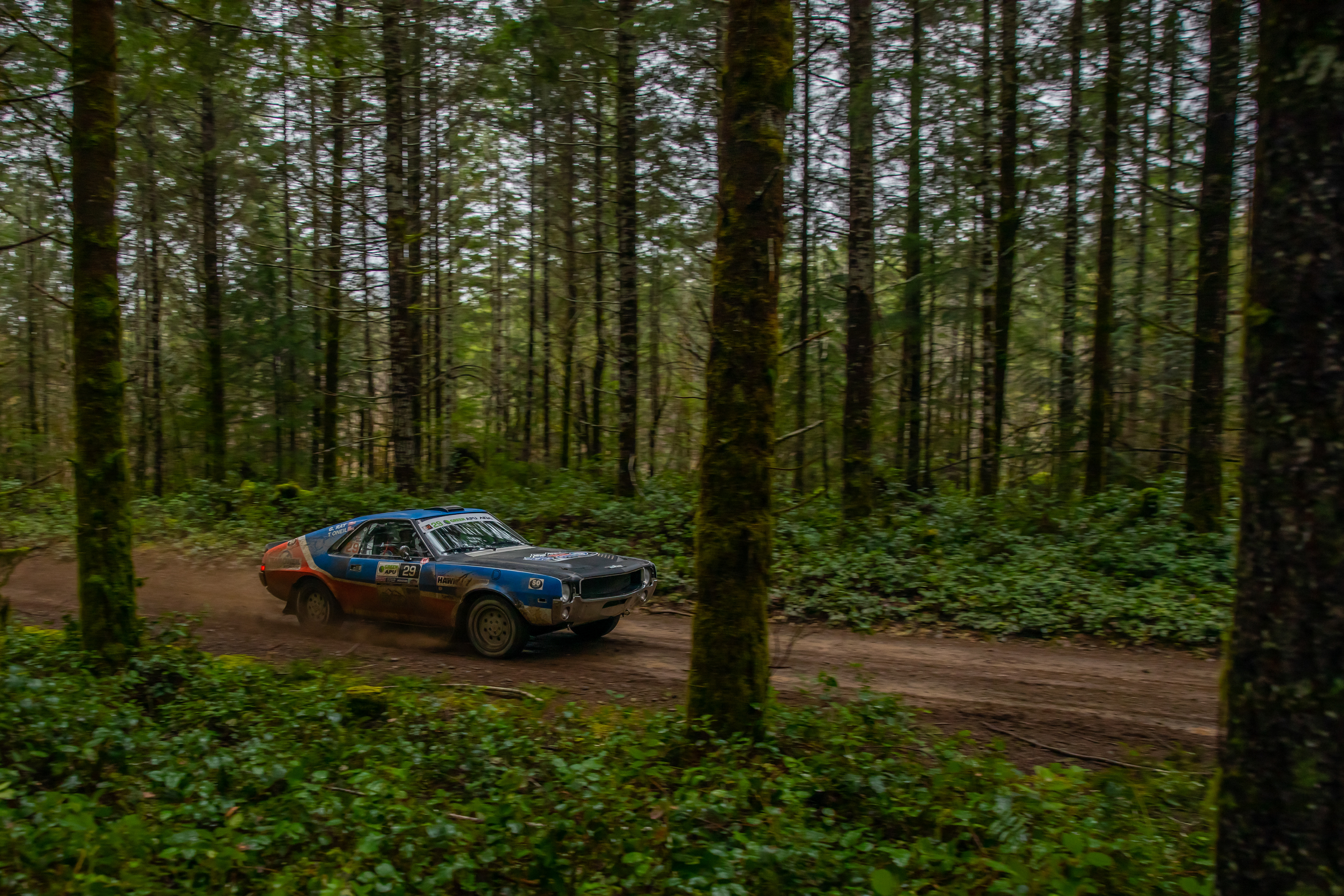 Tim O'Neil's AMC AMX glides through the forest on the Stillwater stage.