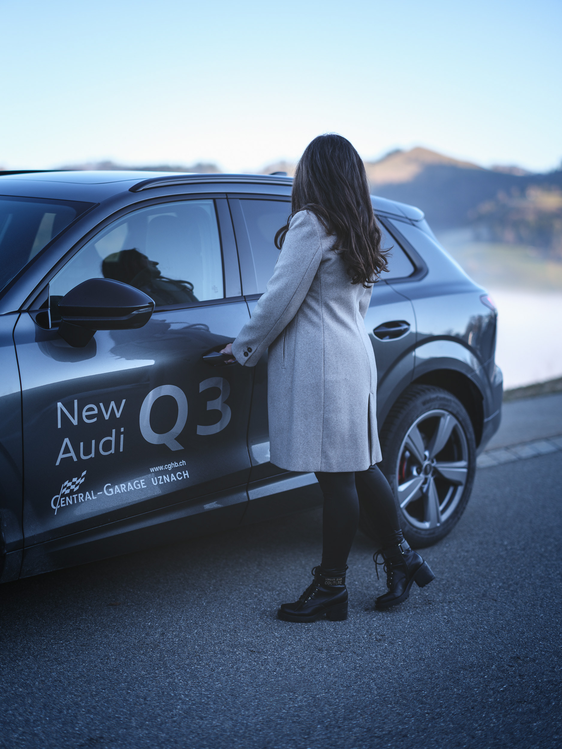Audi Q3 Lifestyle Shot – Woman Opening SUV in Mountain Landscape