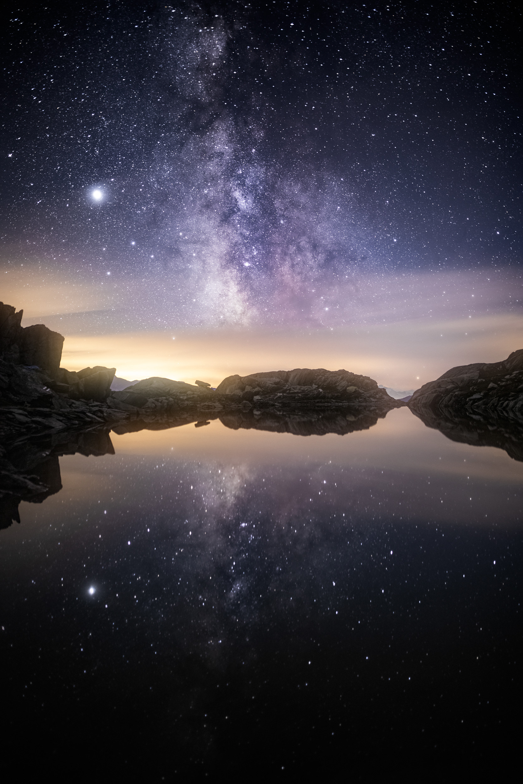 Flash of Light Over Still Lake and Milky Way