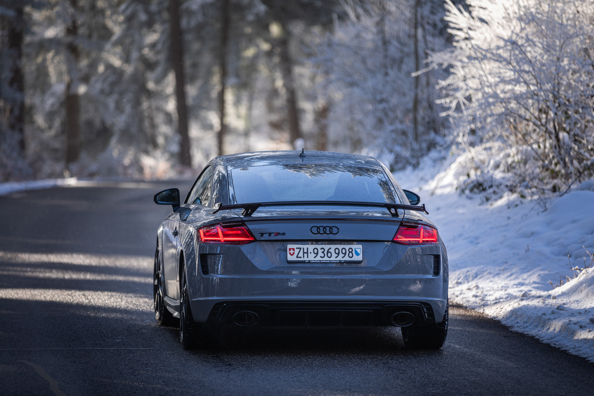 Audi TT RS Rear View on Snowy Road in Winter Forest