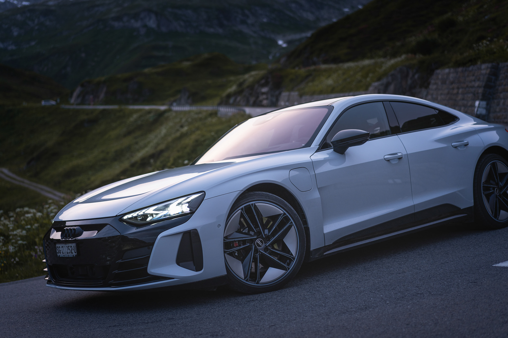 Turning through alpine curve with glowing headlights