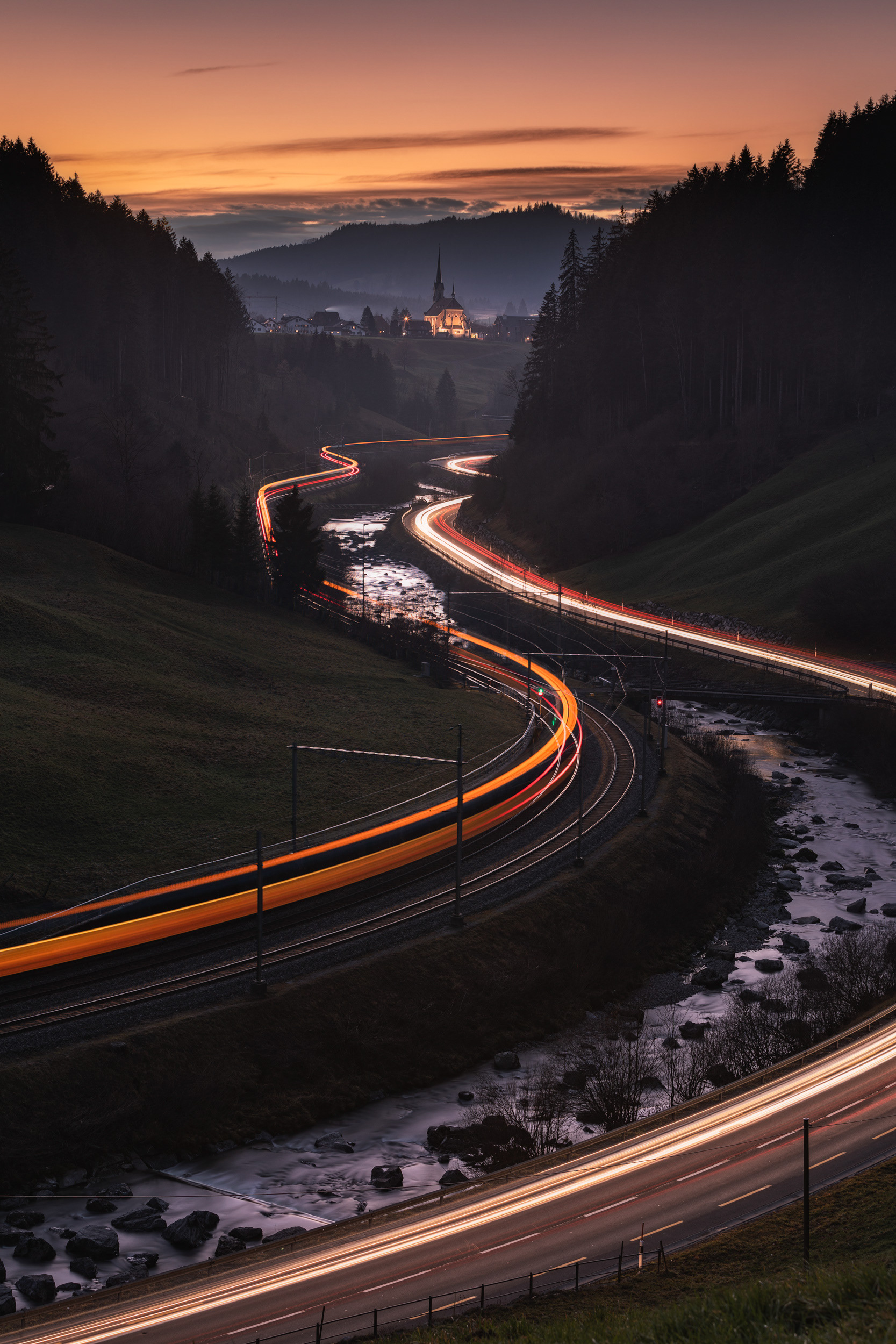 Winding Snowy Road in Einsiedeln, Swiss Alps with Light Trails