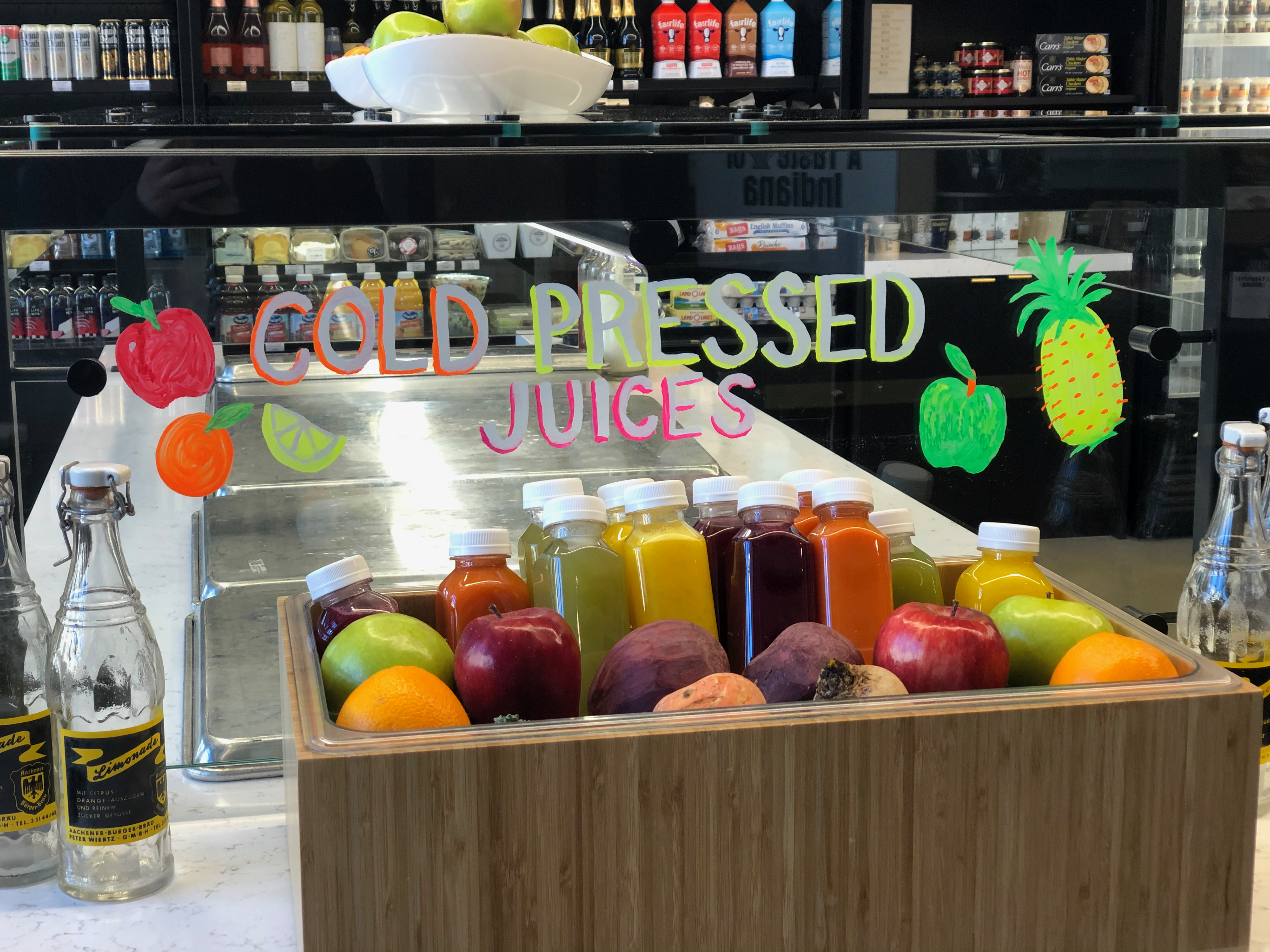 Chalk marker art on glass salad bar sneeze guard