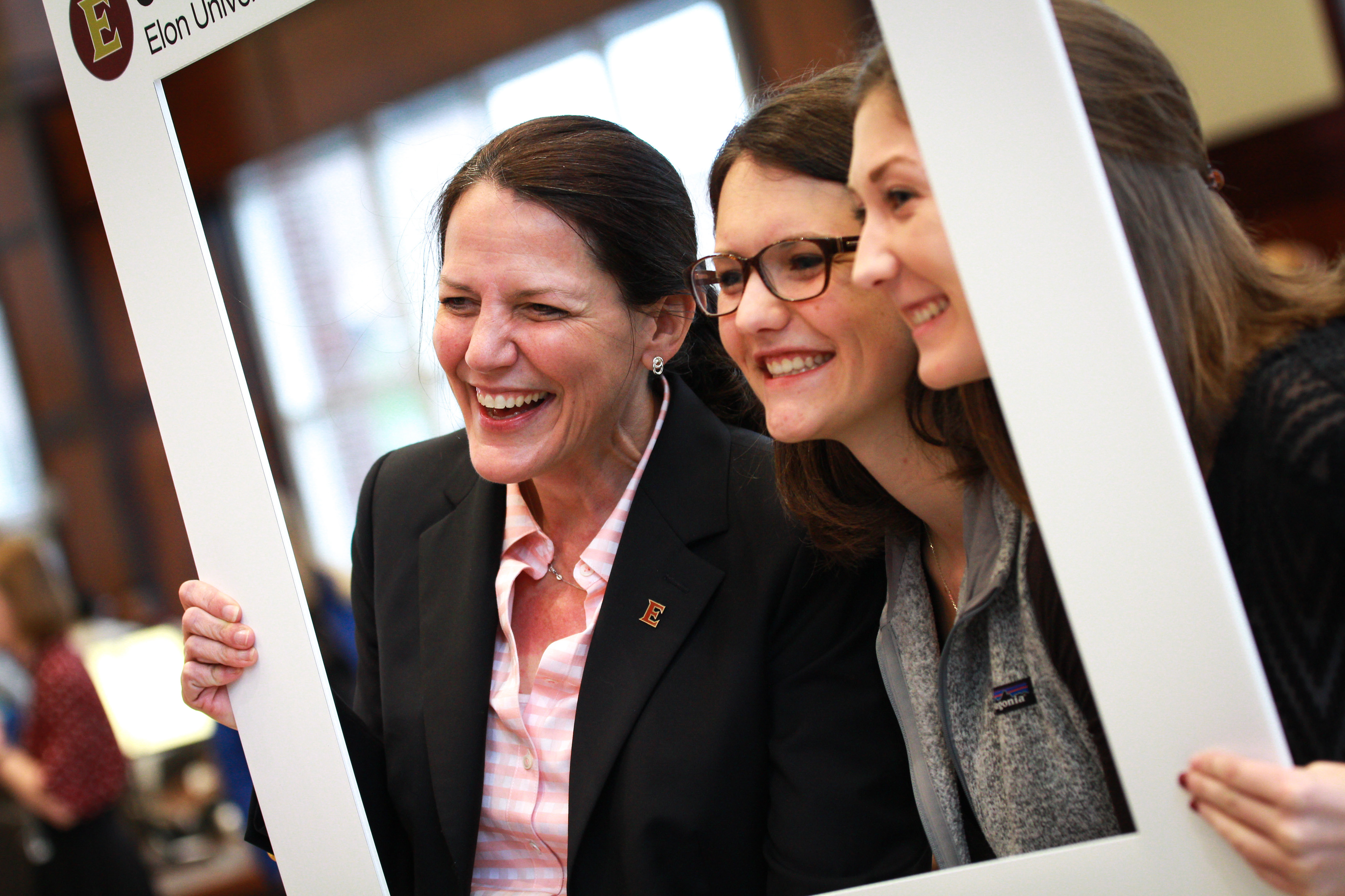 President Connie Book poses with students after her inauguration ceremony as Elon's first woman president.