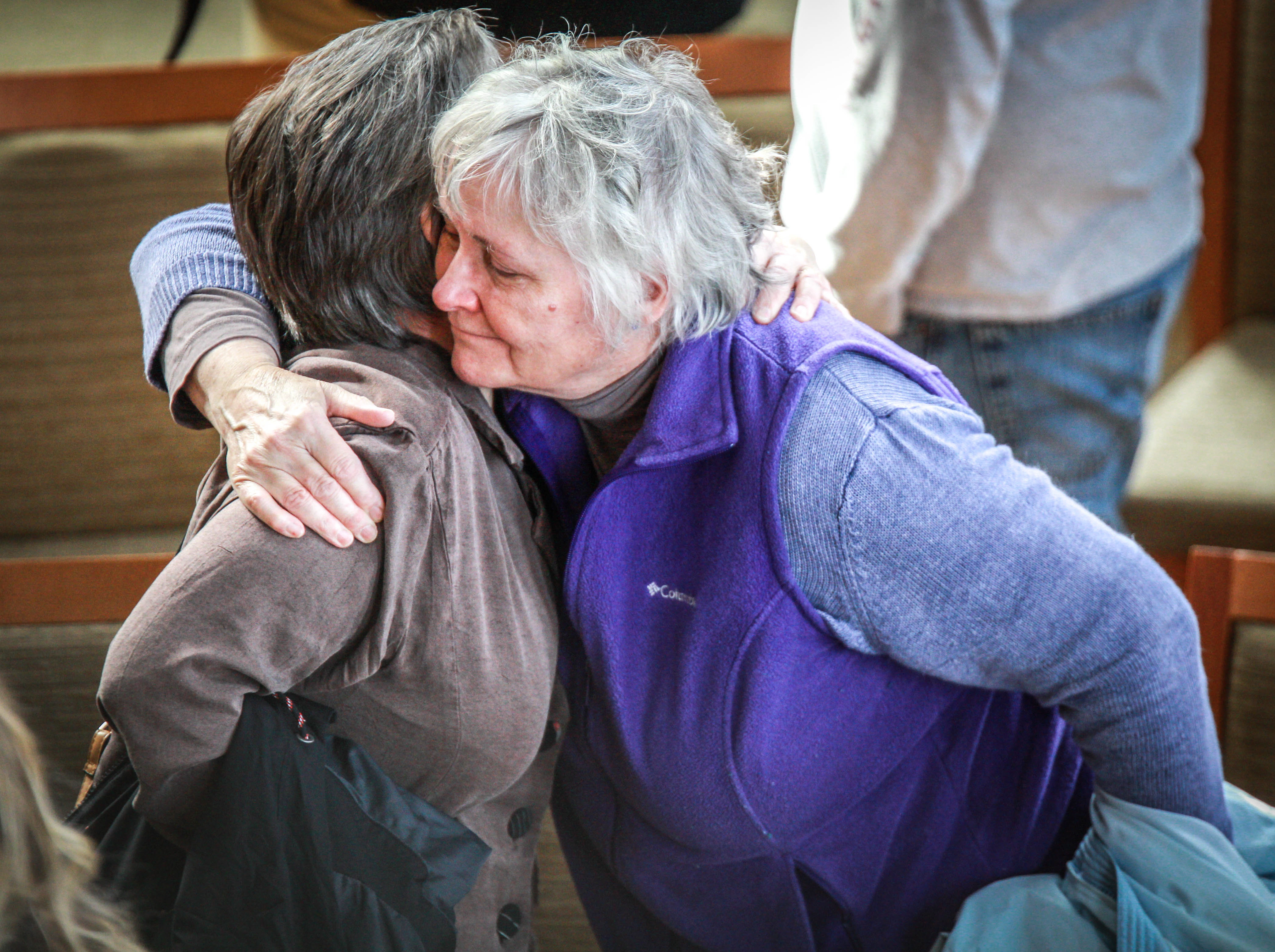 Barbara Rhoades, assistant professor of art, hugs a friend of L.M. Wood as they grieve together during a Gathering of Friends following Wood's sudden death on Tuesday, March, 12, 2019.