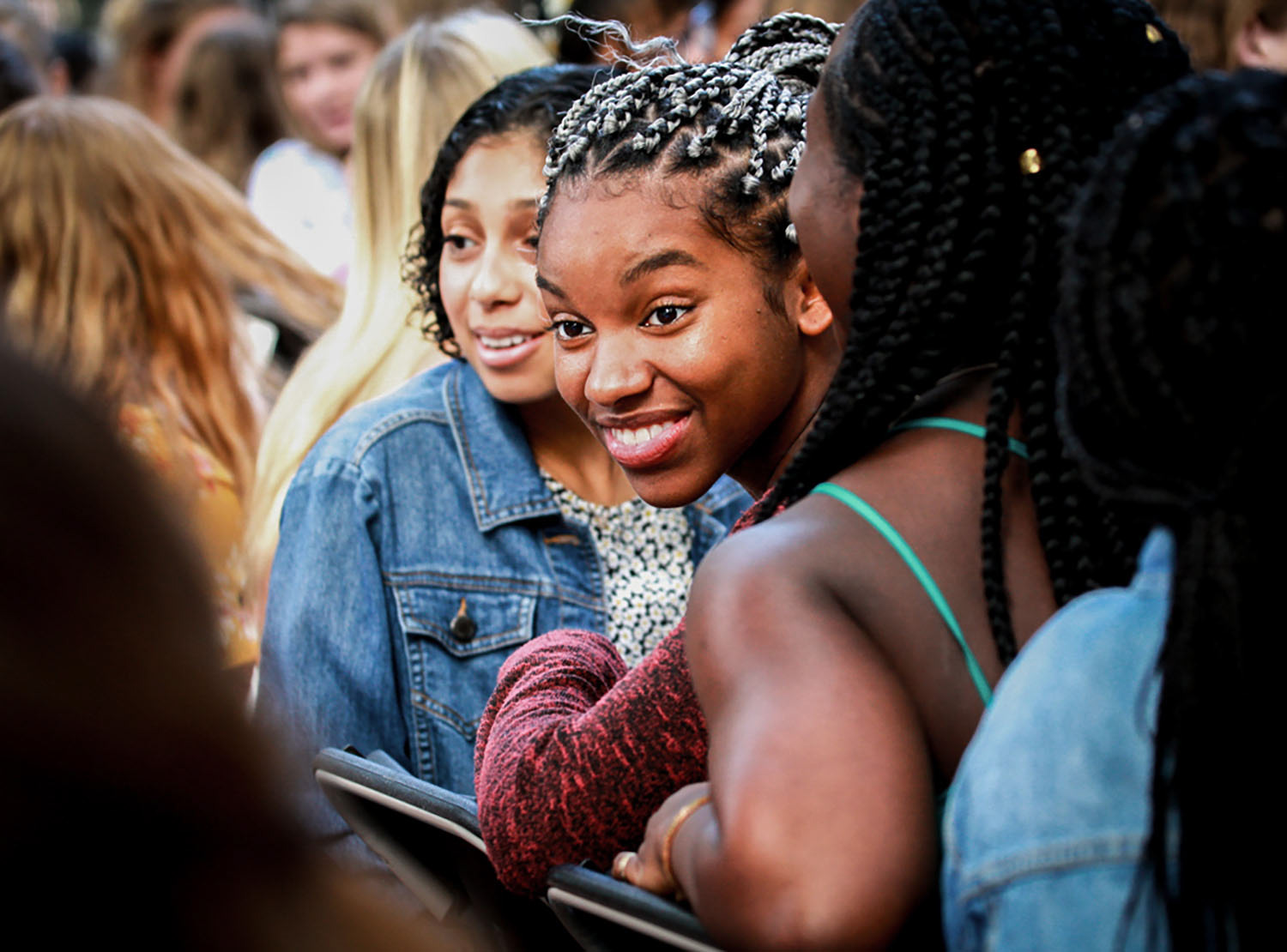 Freshman Paige Wilson smiles during the "know your neighbor" exercise during New Student Convocation at Elon University. The annual tradition involves first-year students introducing themselves to a person unfamiliar to them outside of West Hall on Saturday, August 25, 2018.