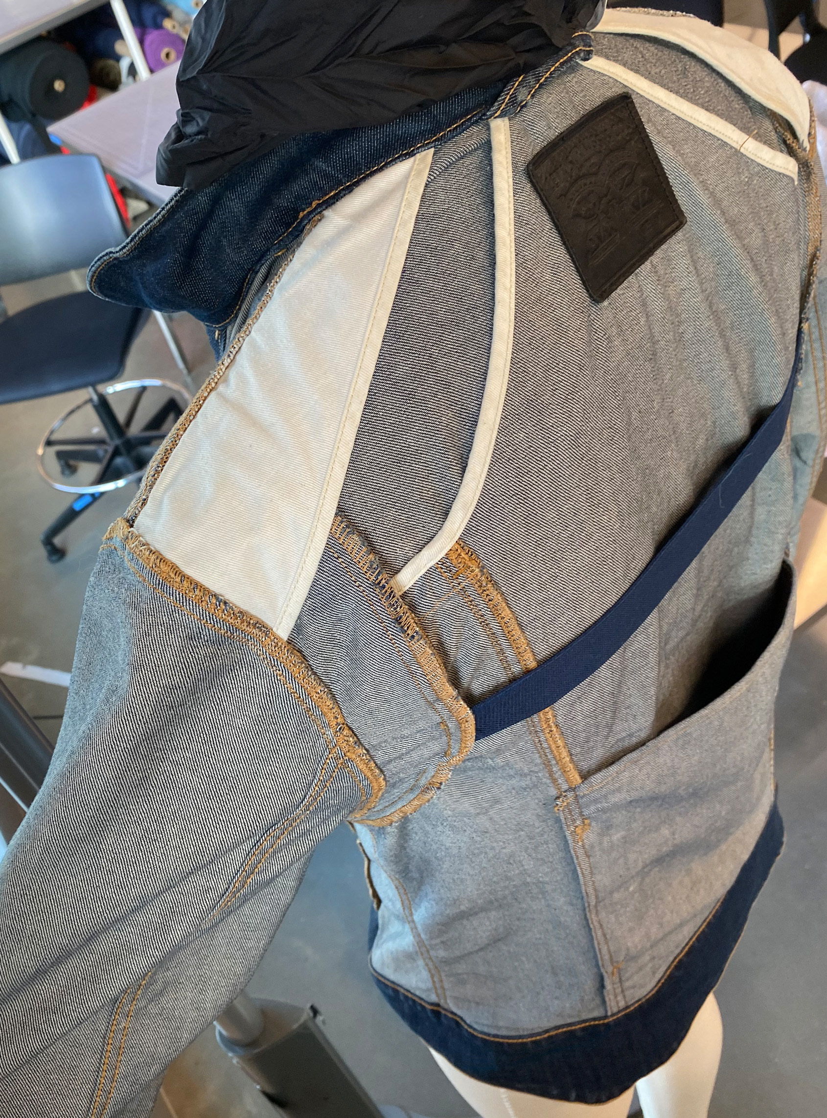 Motorcycle jacket's implementation of an elasticated bi-swing back with facings.