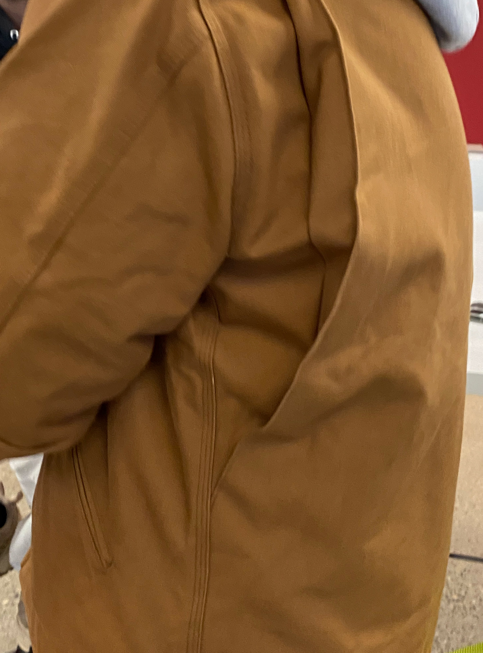 Workwear implementation of a bi-swing articulated back using a facing.
