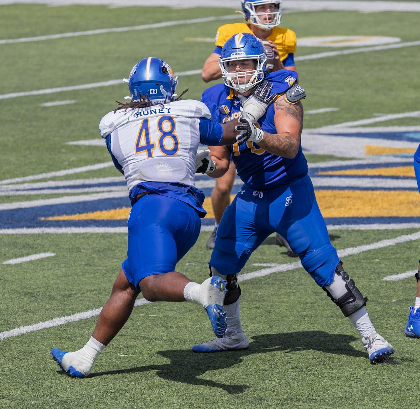 Manuel Serna (76) blocks Dejon Roney (48)