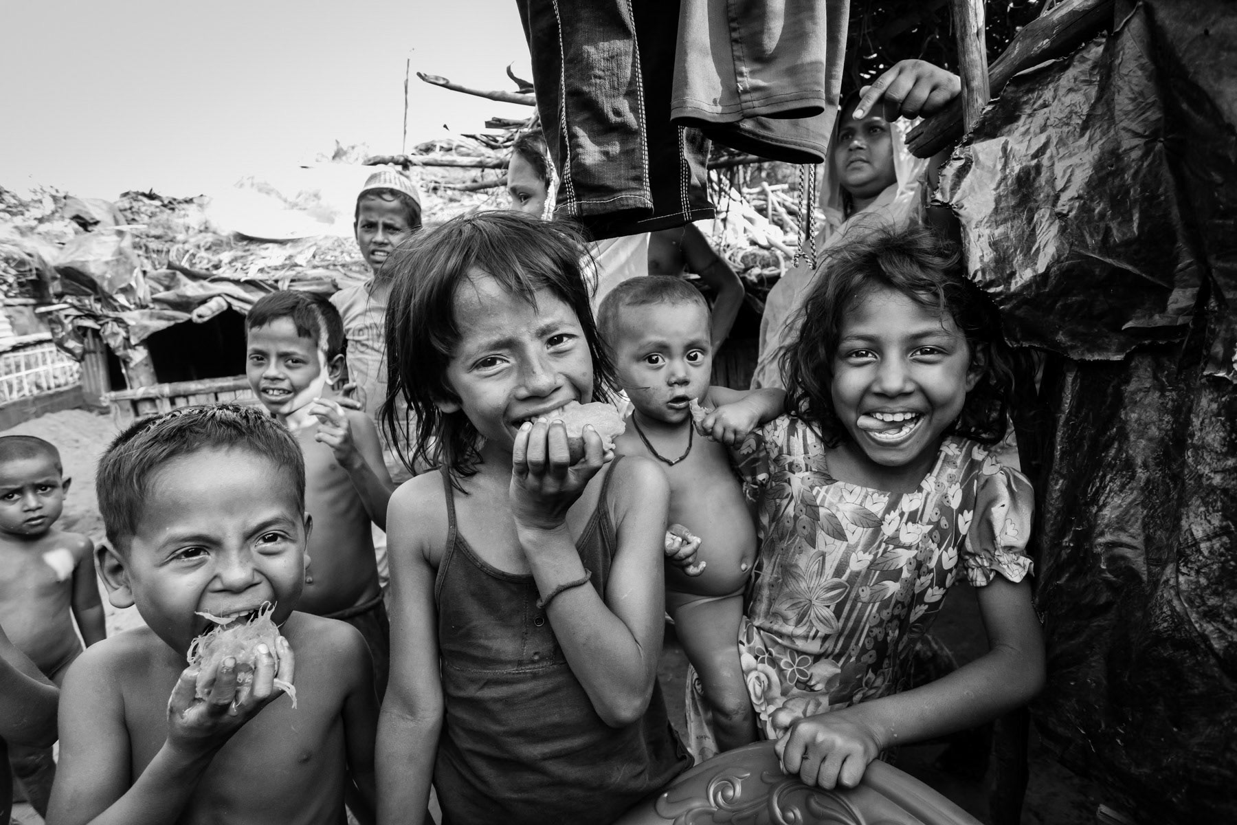 Rohingya children in a moment of joy eating mango. Shamlapur refugee camp, Teknaf, Bangladesh, May 2017