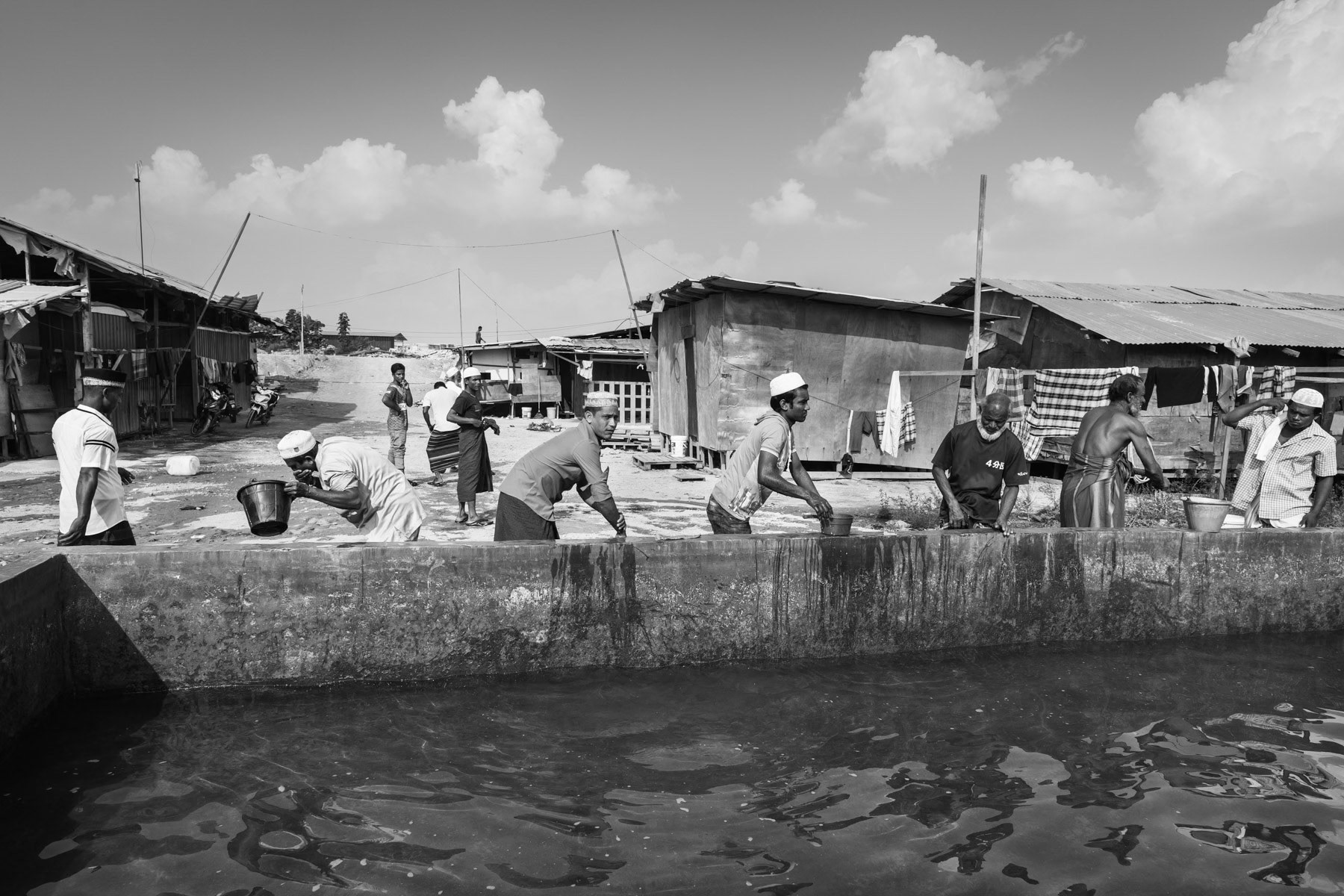 Rohingya construction workers performing ablution before friday prayers. MBI construction site, Desa Ku in Kedai, Malaysia, June 2017