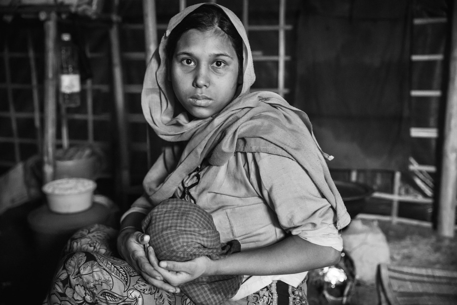 Mother and her one month old daughter fled from Thami village near Buthidaung in Rakhine state. Her husband was hit by shrapnel in the legs. They walked almost 15 days to reach the Bangladeshi border. More than half a million Rohingya have fled Myanmar since August and the start of the latest military security operations that are now widely qualified as ethnic cleansing campaigns. Kutupalong refugee camp, Ukhiya, Bangladesh, November 2017