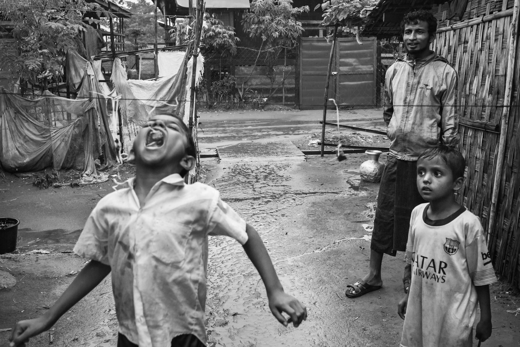 Rohingya children playing catch the sweets, Baw Du Pha IDP camp for internal displaced Rohingya, Sittwe township, Myanmar, October 2016