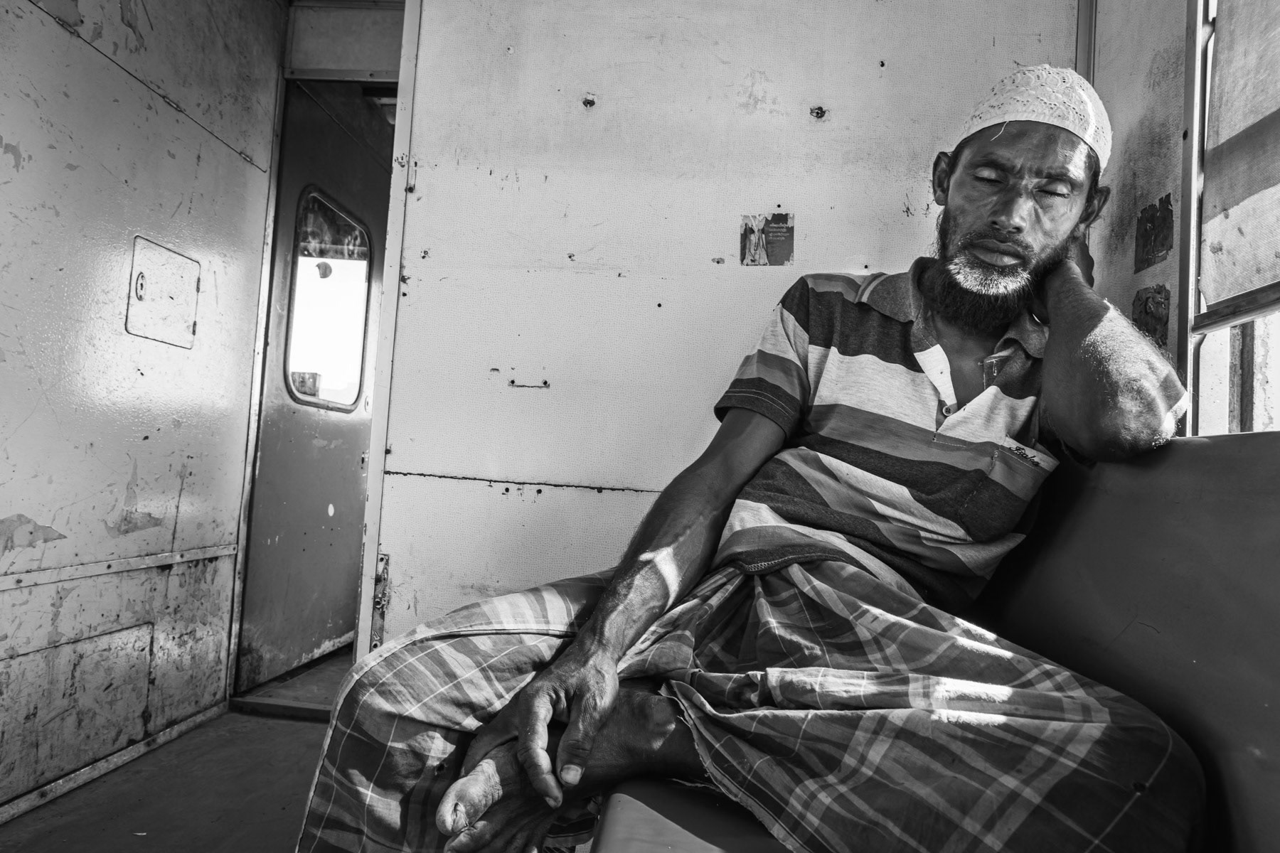 A Rohingya man travelling by train to visit relatives living in a nearby IDP camp. Sittwe township, Myanmar, September 2019