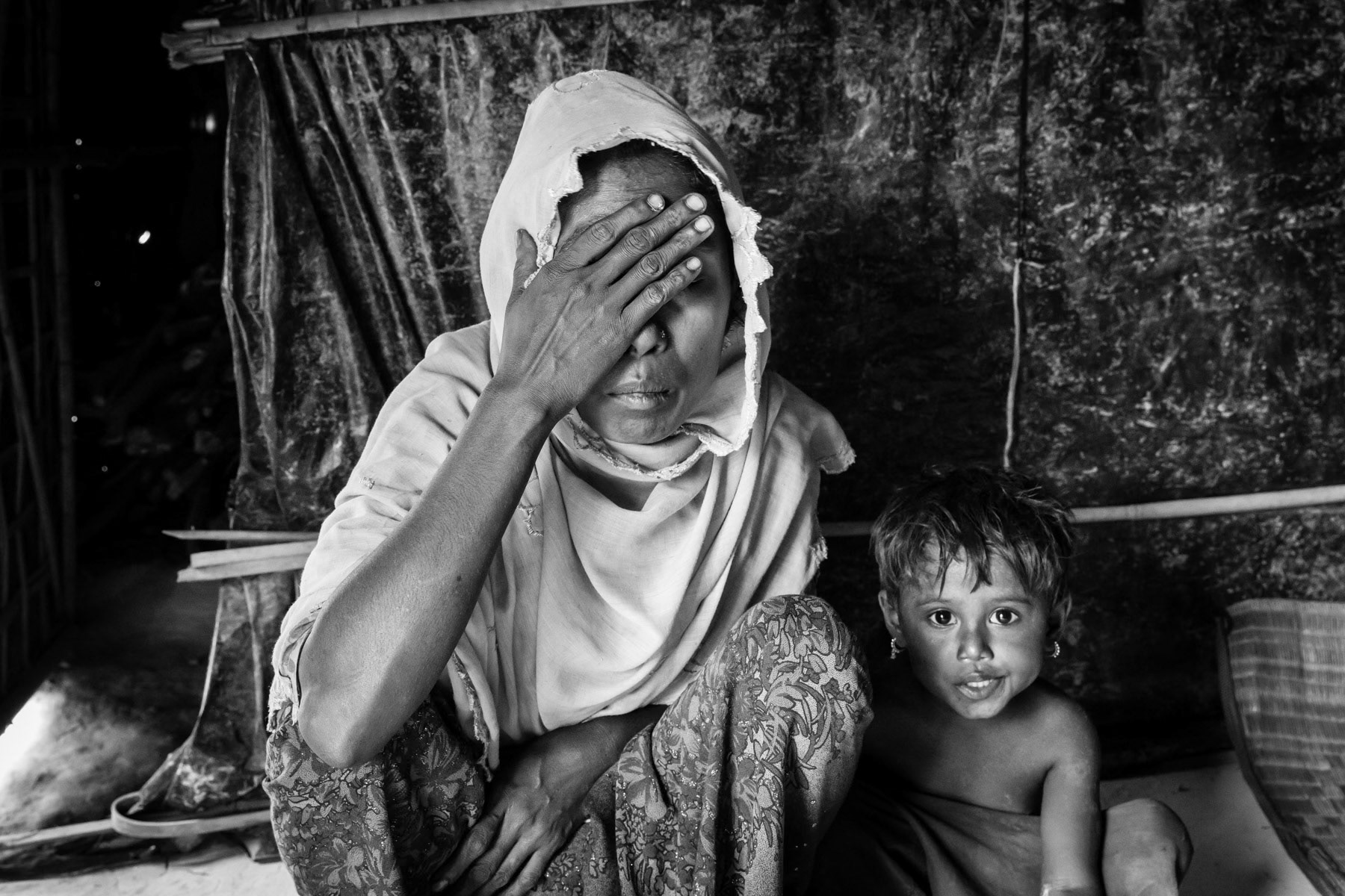Dilnuaj, 30 years old, exhausted after fleeing persecution in Maungdaw Township in Myanmar. Her husband was taken away by the security forces of Myanmar few months ago, she has never heard from him anymore. Kutupalong camp for Rohingya refugees from Myanmar, Cox's Bazar, Bangladesh, May 2017