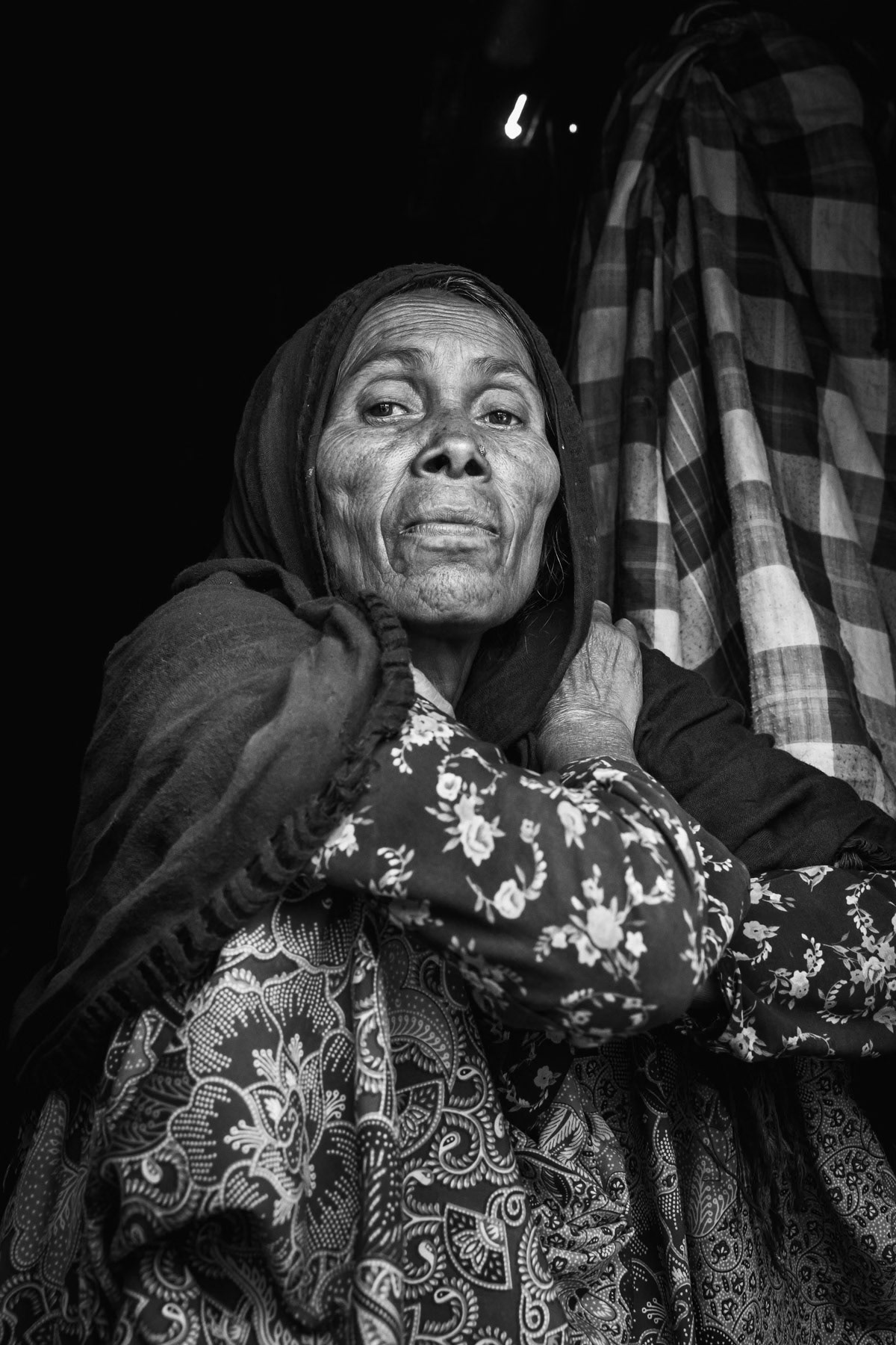 Elderly Rohingya woman living with her disabled son. Fled to Bangladesh after her husband was arrested by Myanmar security forces. She has no news about his whereabouts and presumes that he has been killed. Kutupalong refugee camp, Bangladesh, May 2017