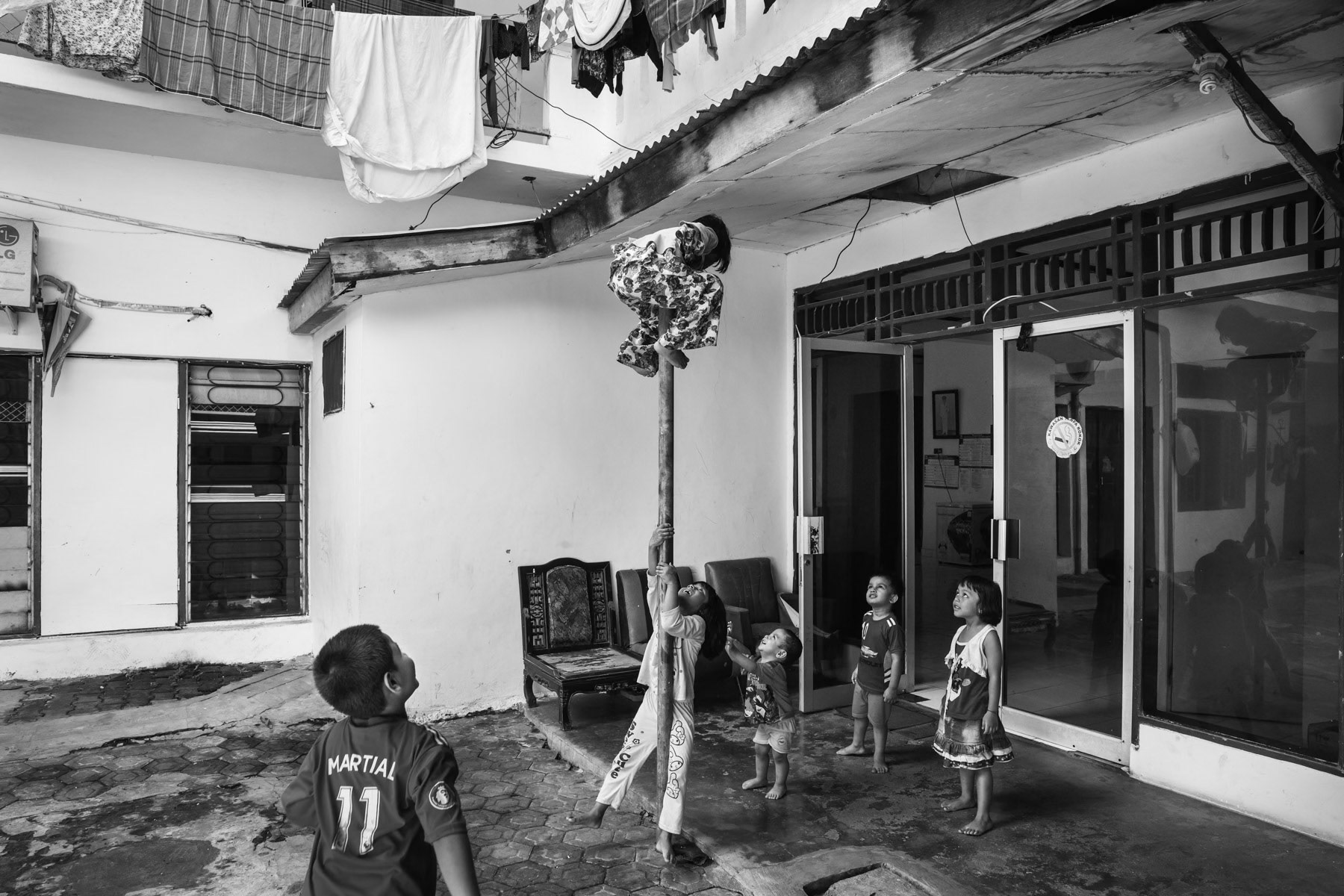 Rohingya refugee children playing in a restrained area within the collective centre where they reside with their parents awaiting a long over due resettlement in a third country. Most Rohingya caught up in Indonesia where on their way trying to reach Australia in 2012. They live in limbo ever since . Makassar in South Sulawesi, Indonesia, November 2018
