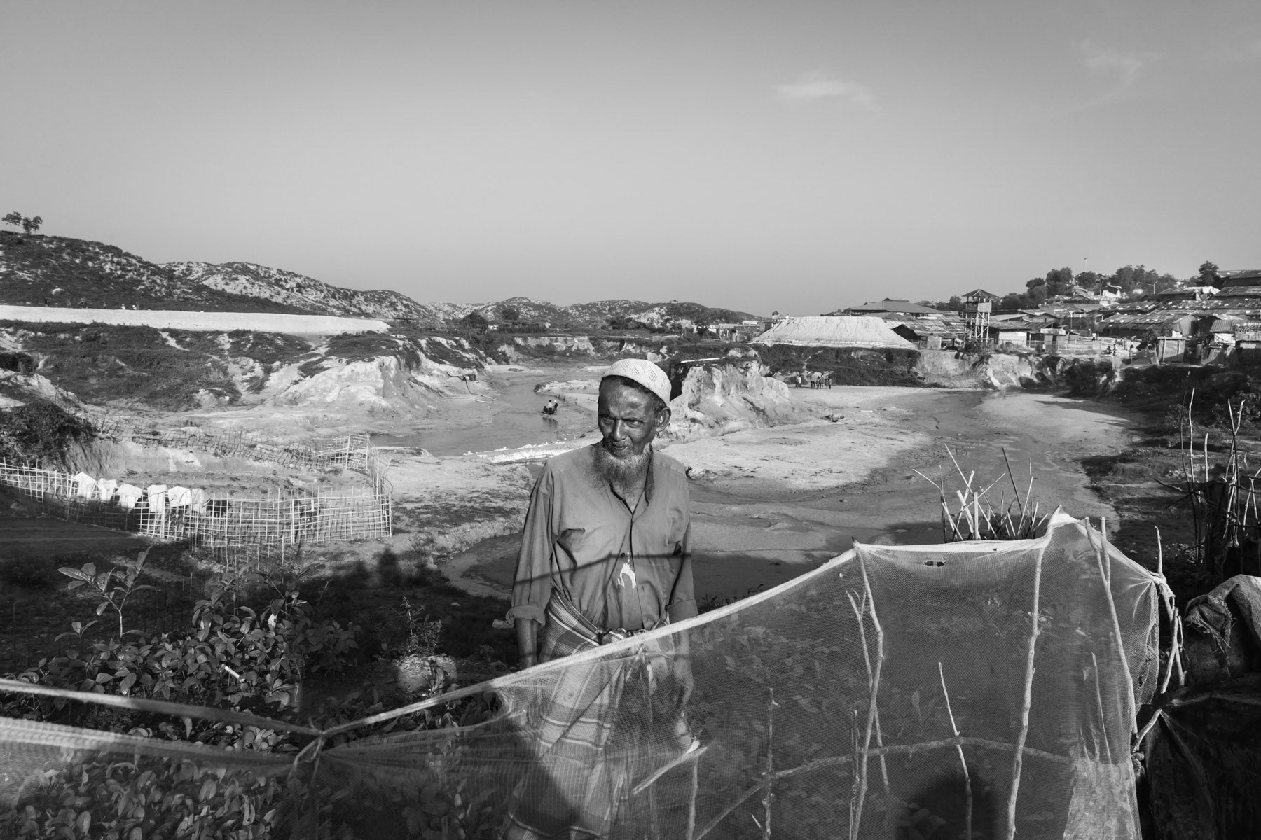 A Rohingya refugee in his small vegetable garden. Over a million refugees from Myanmar populate the camps of Southern Bangladesh. Empty spaces within the camps are extremely rare and having the possibility to grow vegetables is rather exceptional. Thangkhali refugee camp, October 2018