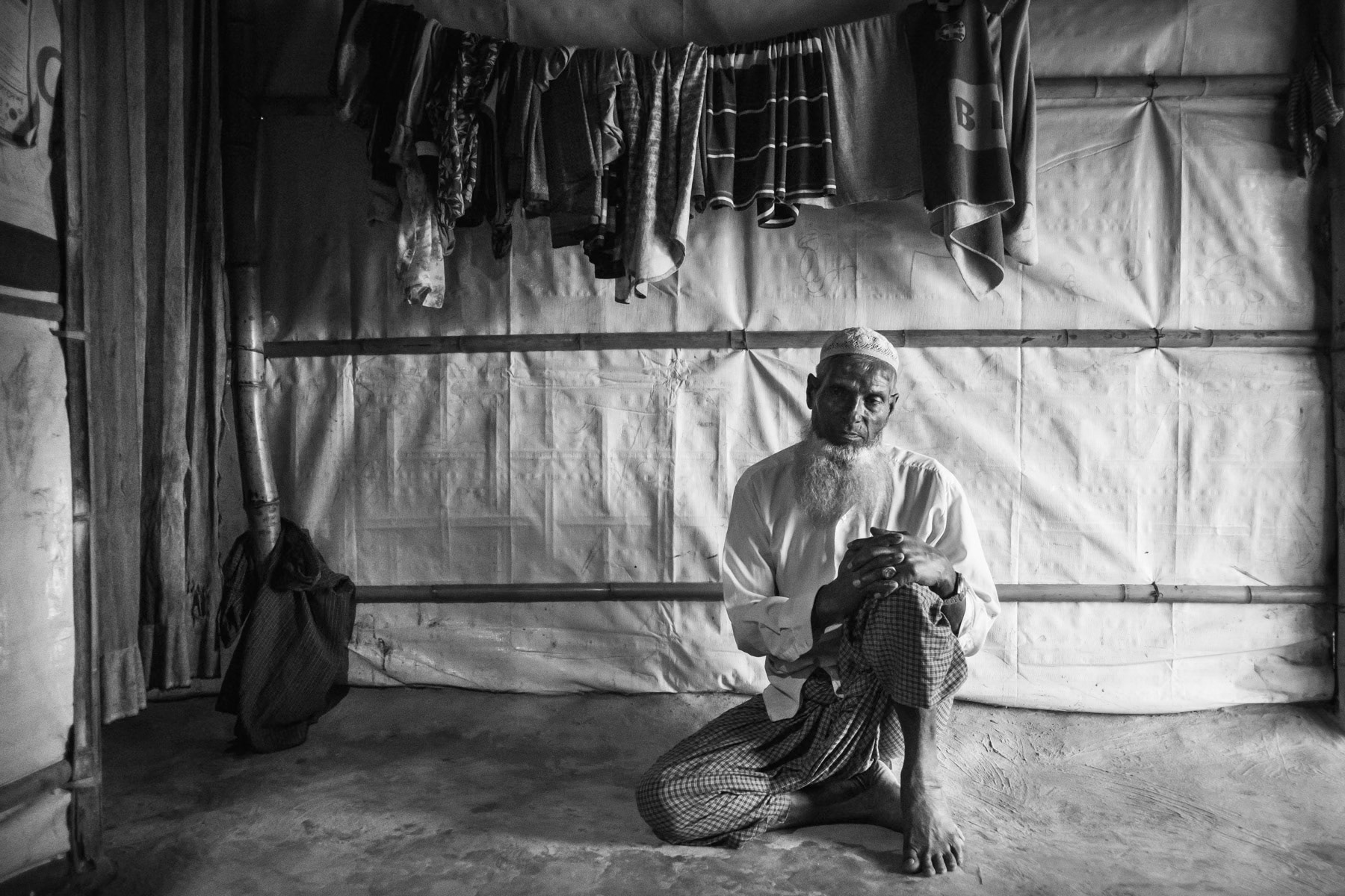 Hanifa, 60 years, a Rohingya refugee from Maungdaw township. worked all his life as a farmer untill his village was attacked by the Burmese military in August 2017. He was hit by mortar shrapnel during the attack but managed to escape with his wife and 3 children. They all live safely in the refugee camps along the border. Thangkhali refugee camp, Bangladesh, October 2018