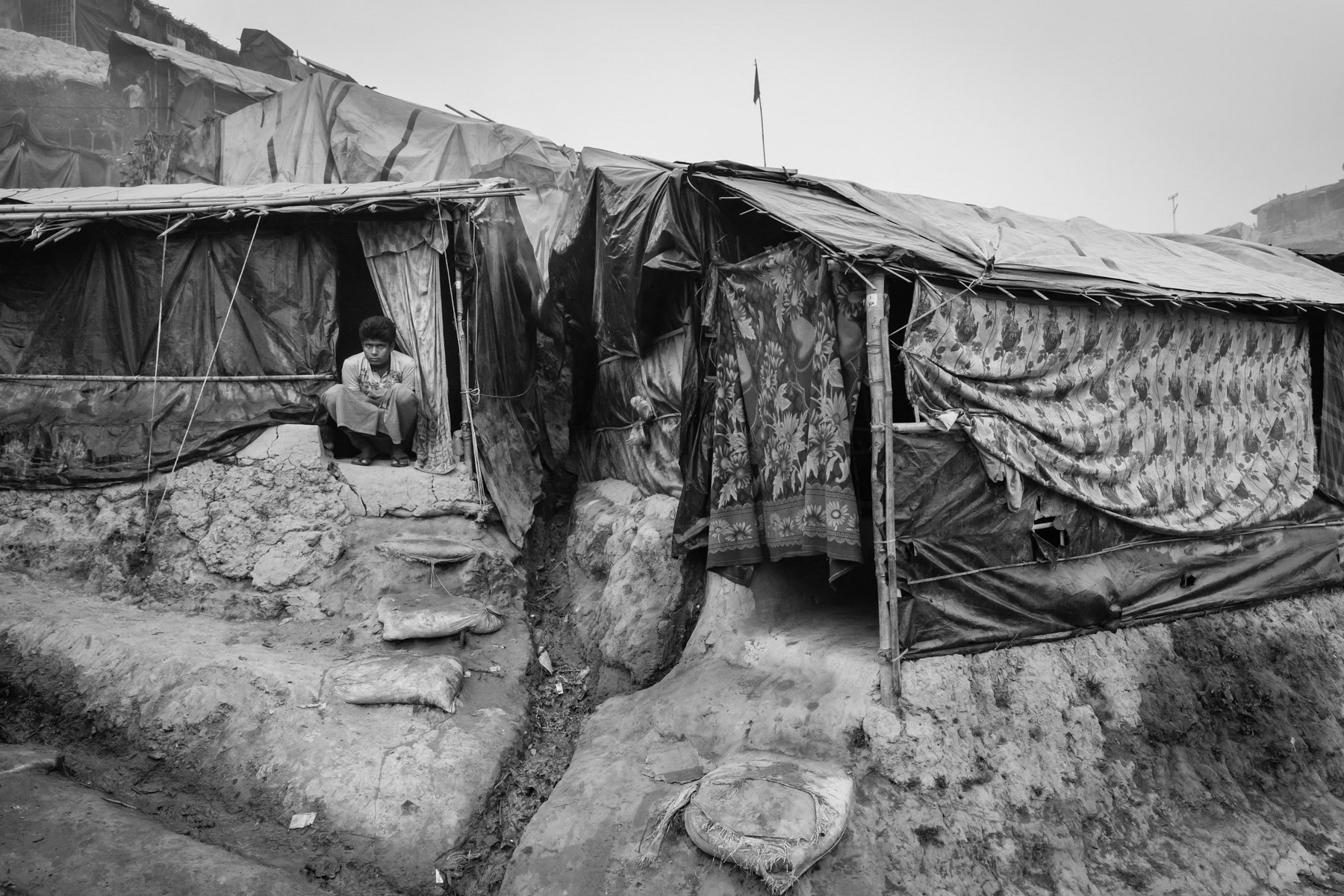 A newly arrived Rohingya refugee at a new extension of the already overcrowded refugee camps to shelter part of the 650,000 newly arrived Rohingya refugees. The Rohingya refugee camps are now sheltering Rohingya victims of the 1978, 1992, 2008, 2012, 2016 and 2017 ethnic cleansing campaigns. By begining 2018 more than one million Rohingya refugees live in tha camps near Cox's Bazar making it the largest refugee camps in the world. Balukhali section, Ukhiya, Bangladesh, March 2018