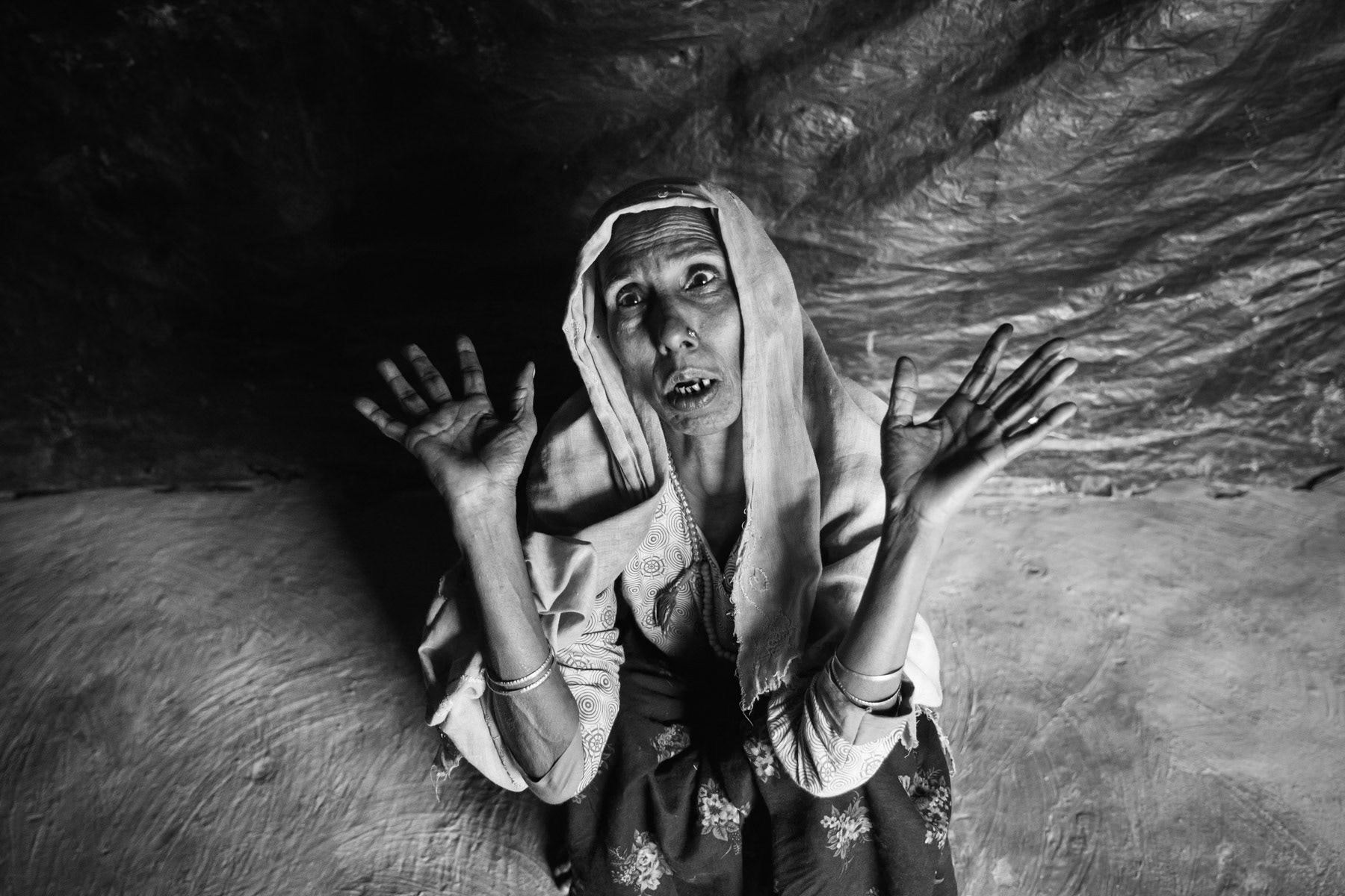Nurashah Khatun, 60 years old Rohingya refugee from Maungdaw township in Myanmar. Her village was attacked in August 2017, she reached Bangladesh after 2 days walking. She lost track of her husband and 17 year old daughter, they have been missing ever since. She lives in Balukhali refugee camp with her 4 surviving daughters ever since. Human rights organisations have stated that thousands of Rohingya have been killed and missing ever since the military operations in Northern. Thousands of girls and women have been tortured and systematically raped in a situation that has evolved from ethnic cleansing to genocide. Balukhali camp for Rohingya refugees, Bangladesh, October 2018