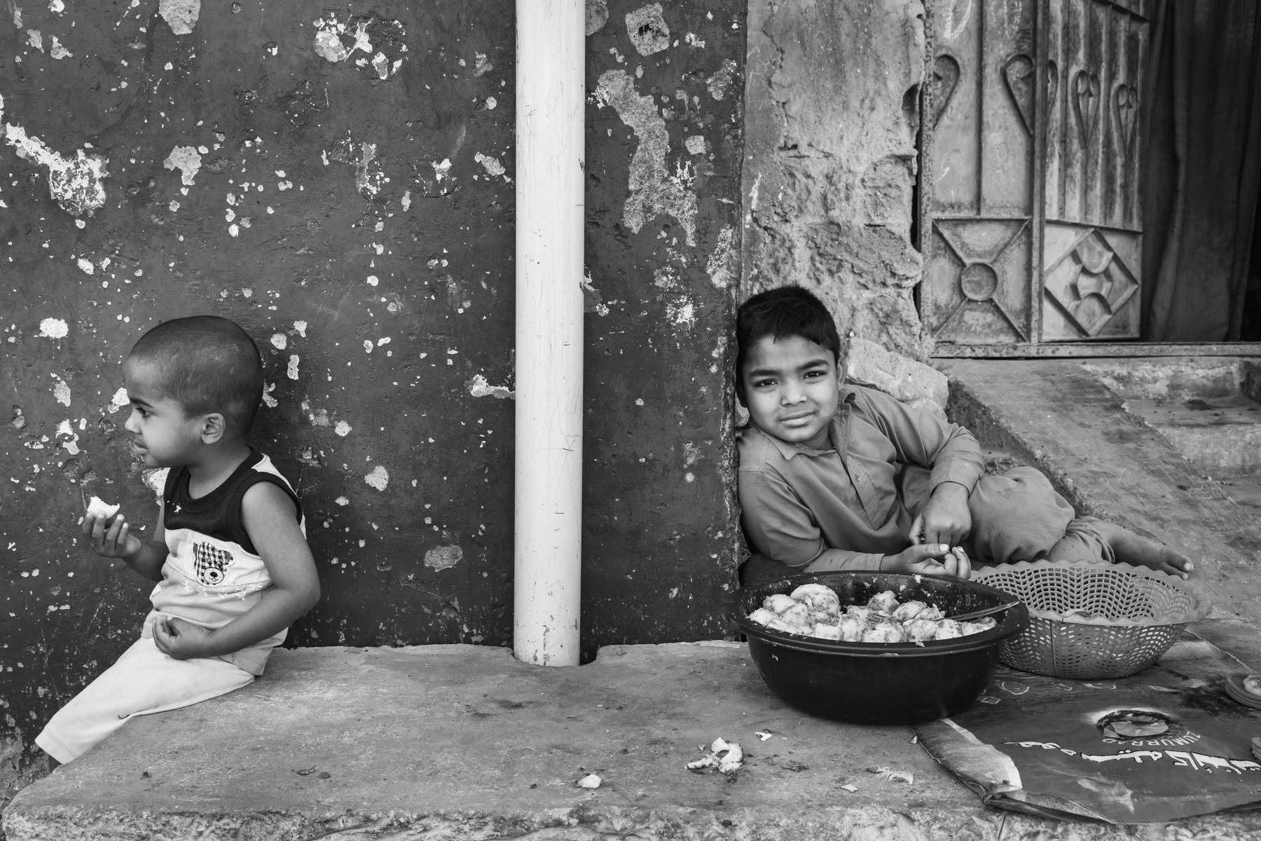 Kids selling street food, Rohingya area of Arkanabad, Karachi, Pakistan, March 2018