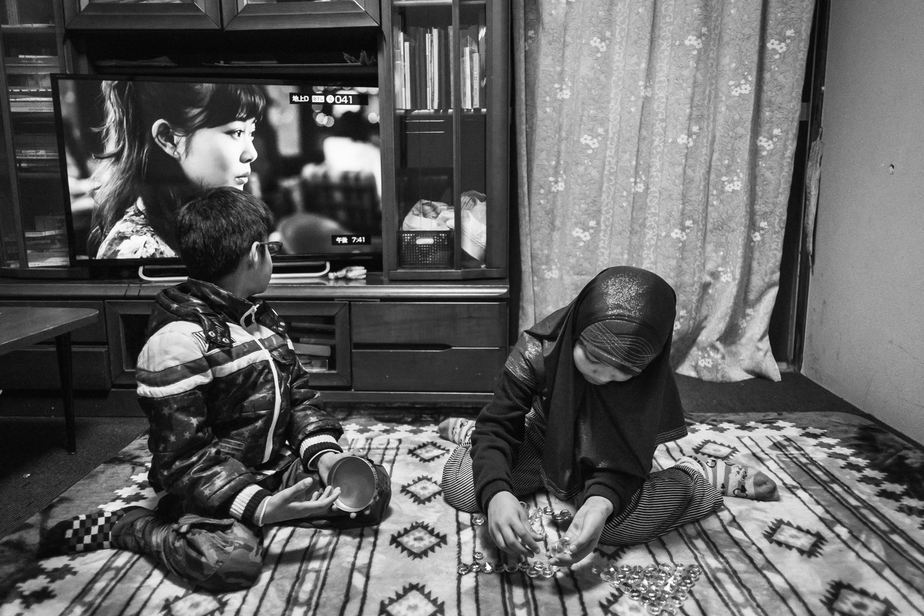 Rohingya children watching television at home. All grew up in Japan after their parents moved their from Myanmar. Tatebayashi, Japan, January 2017