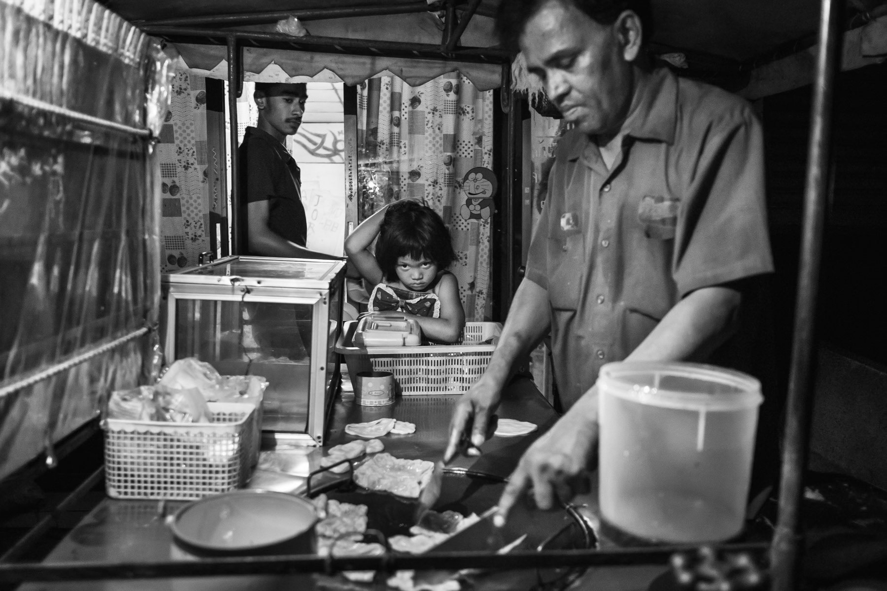 Sultan, a Rohingya refugee already 30 years in exile, preparing roti at home. Nakoneyok, Thailand, June 2016