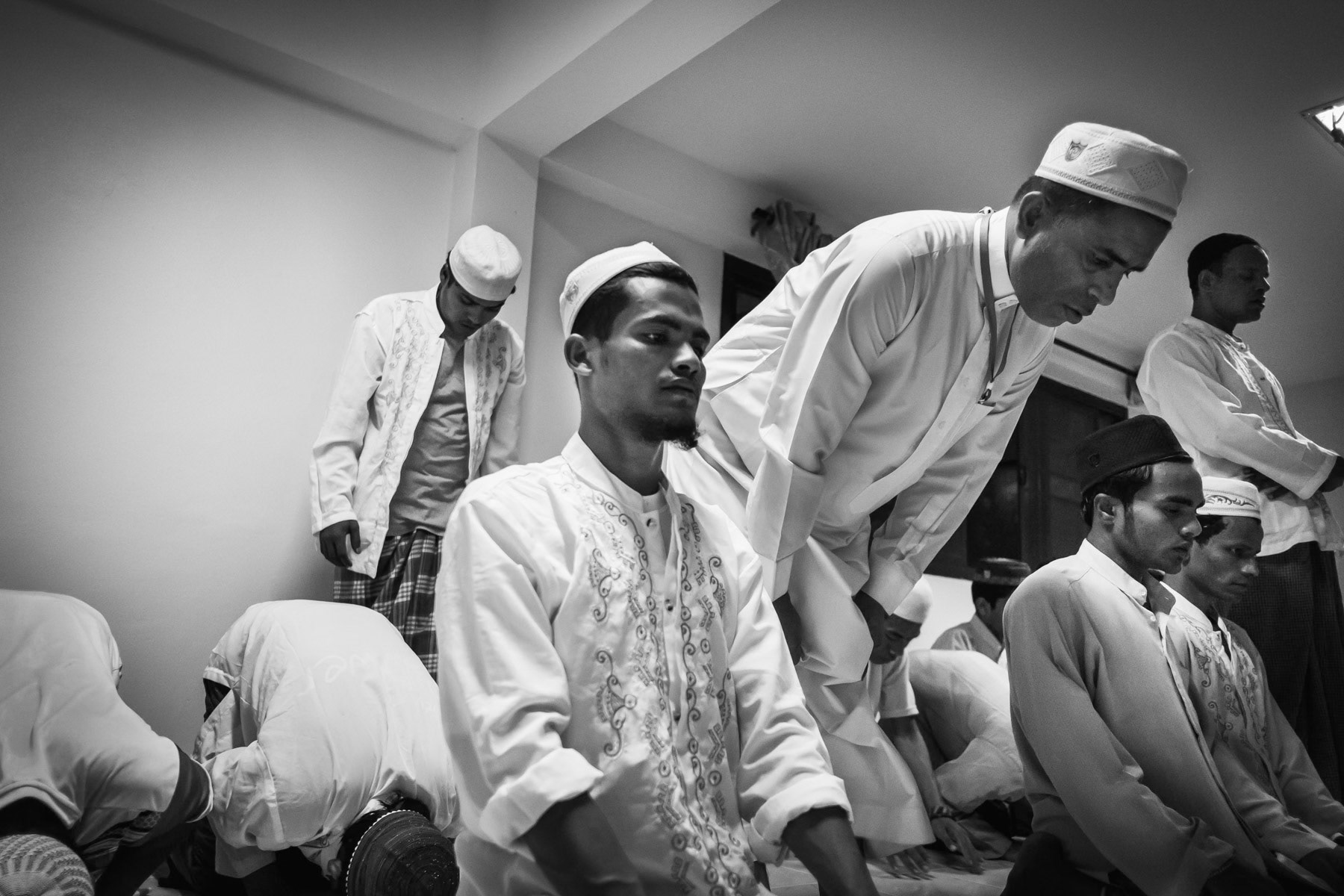 Rohingya refugees praying during the break of fast. Transit Camp for persons victim of human traffickers. About 100 people of which 30 Rohingya children and adults. Closed structure with no possibility for exit or visits. Victims usually remain several years before being resettled in third countries. Tanyaburi closed transit facility, Bangkok, Thailand. June 2016